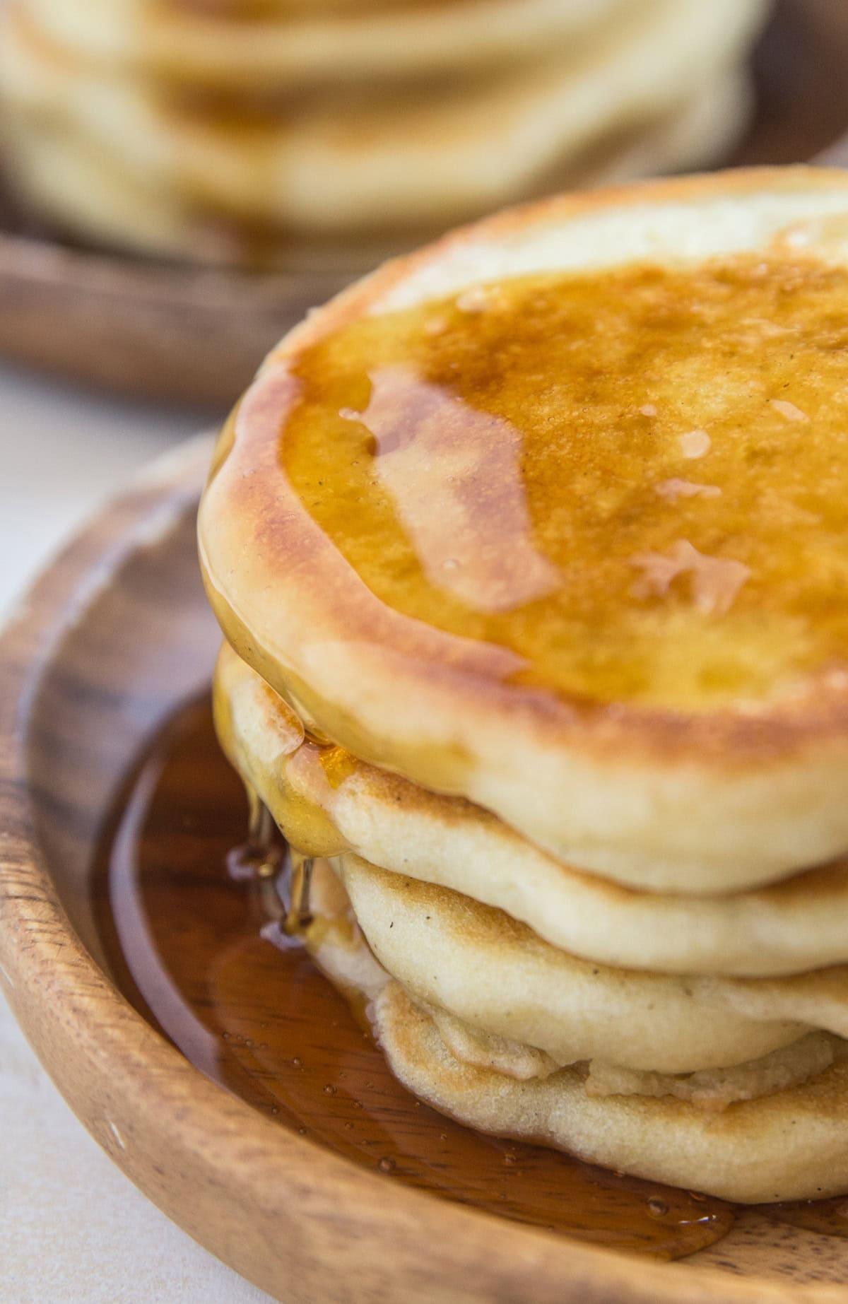 Close-up shot of golden brown sourdough pancakes, fluffy texture visible