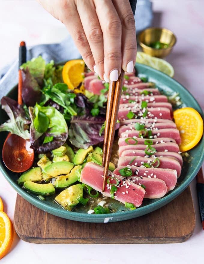 Close-up of sliced tuna tataki with sesame seeds and green onions
