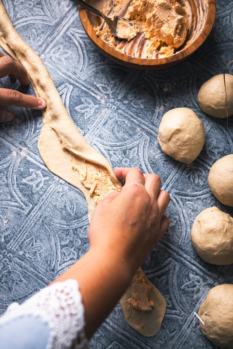 Close up image of mini beer pretzel dough being rolled