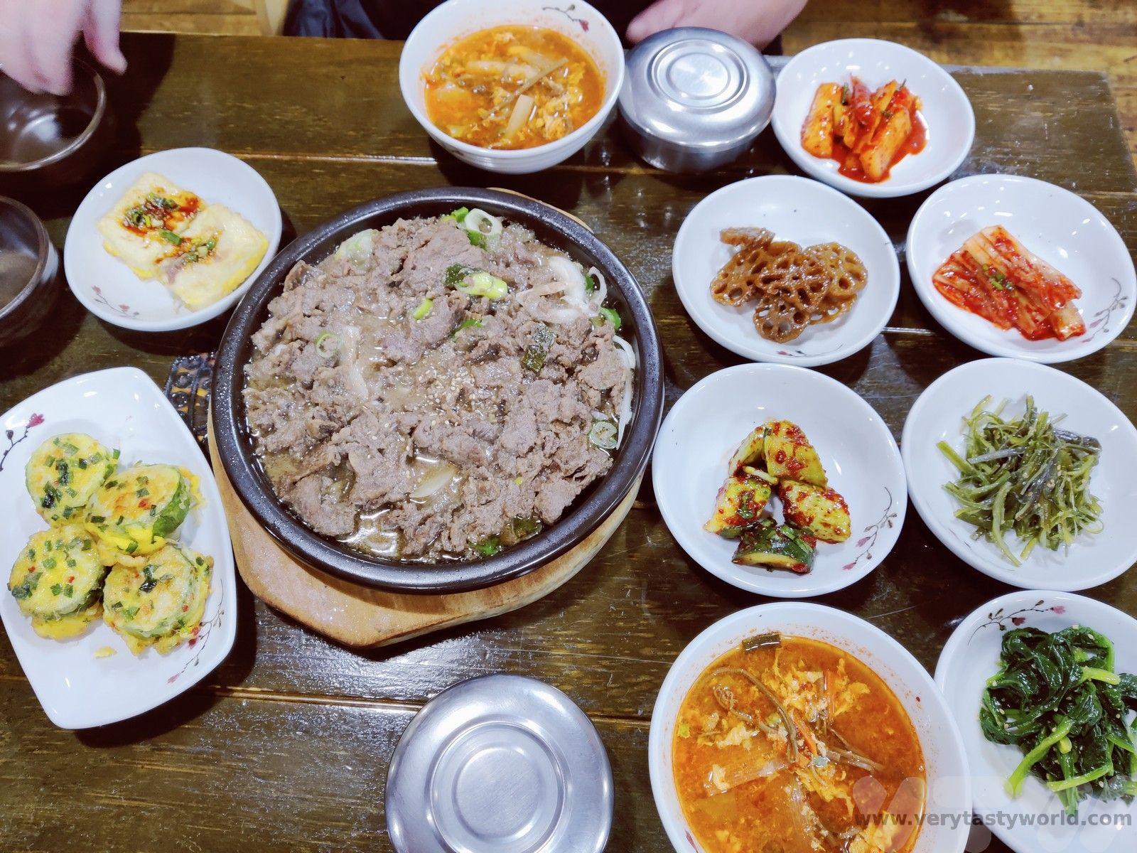 A table set with various Korean dishes, including the wings