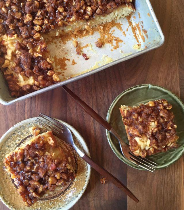 close up of a slice of apple walnut coffee cake showing the apple and walnut filling
