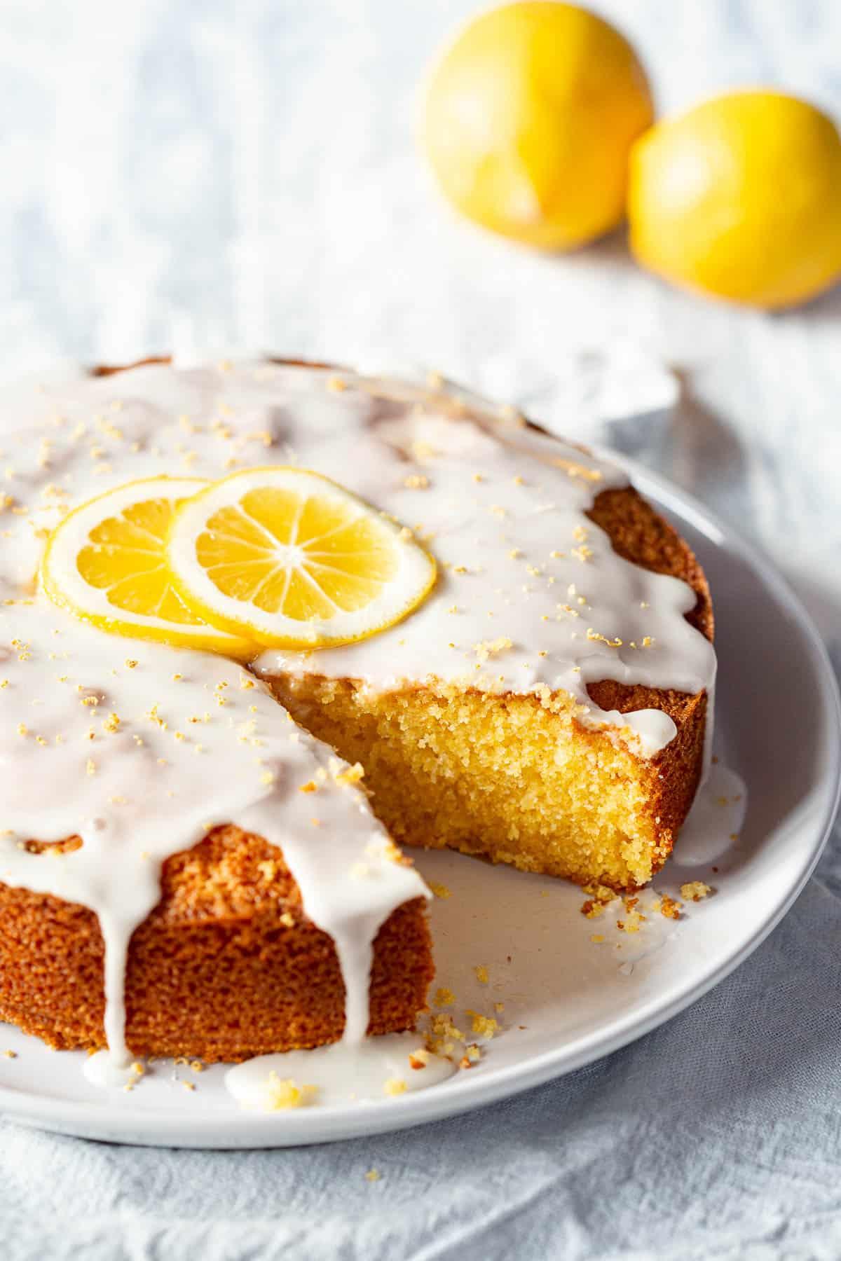 a person slicing a lemon polenta cake