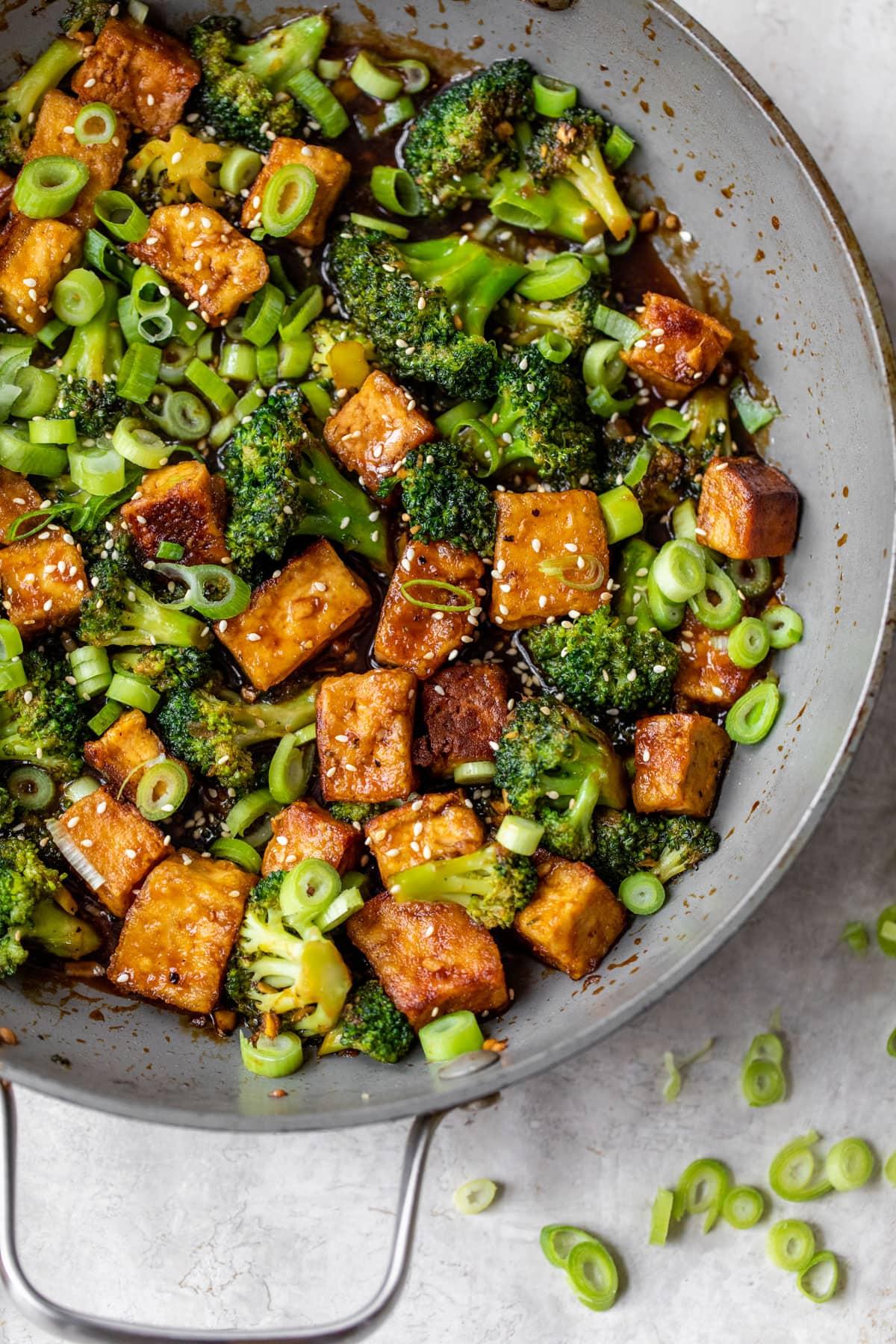 Crispy tofu and broccoli stir-fry in a wok