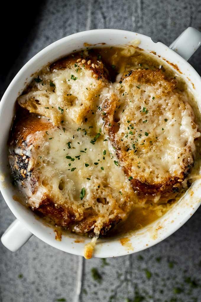 instant pot french onion soup being served in bowls with bread and cheese