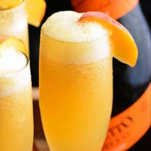 close-up shot of peach bellinis in glasses