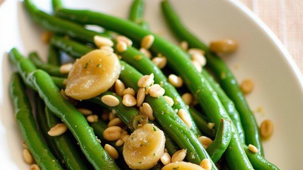 close-up plate of vibrant butter braised green beans with golden shallots, garnished with fresh herbs, soft lighting