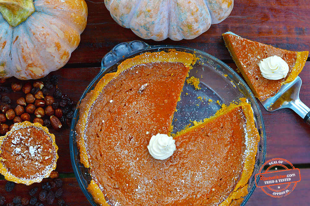 A rustic, home-style pumpkin pie with a visible layer of sauerkraut in the filling, garnished with a sprig of rosemary