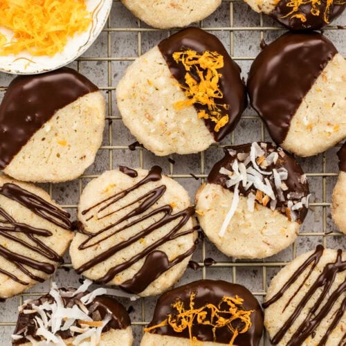 Dreamy cocoa cookies with white drizzle on a cooling rack, close-up, rustic background