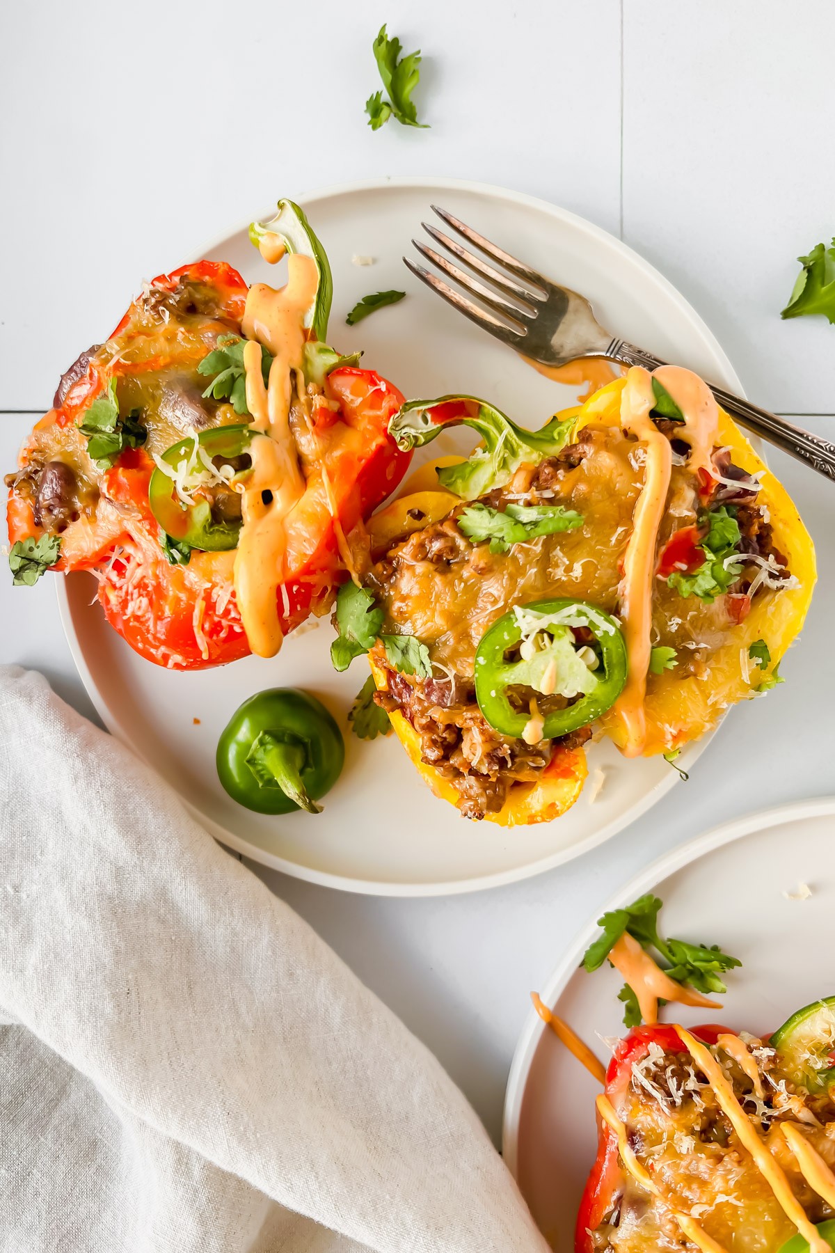 Tortilla Española stuffed inside colorful bell peppers, served on a rustic plate