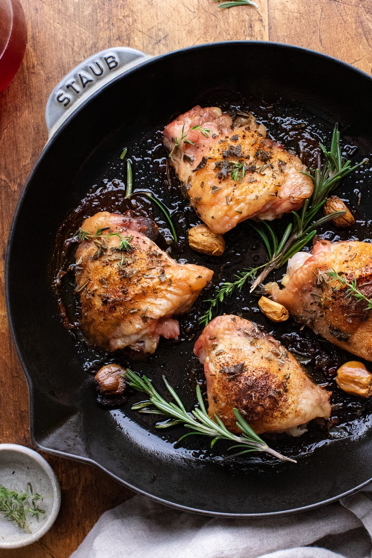 golden brown herb-crusted chicken thighs roasting pan
