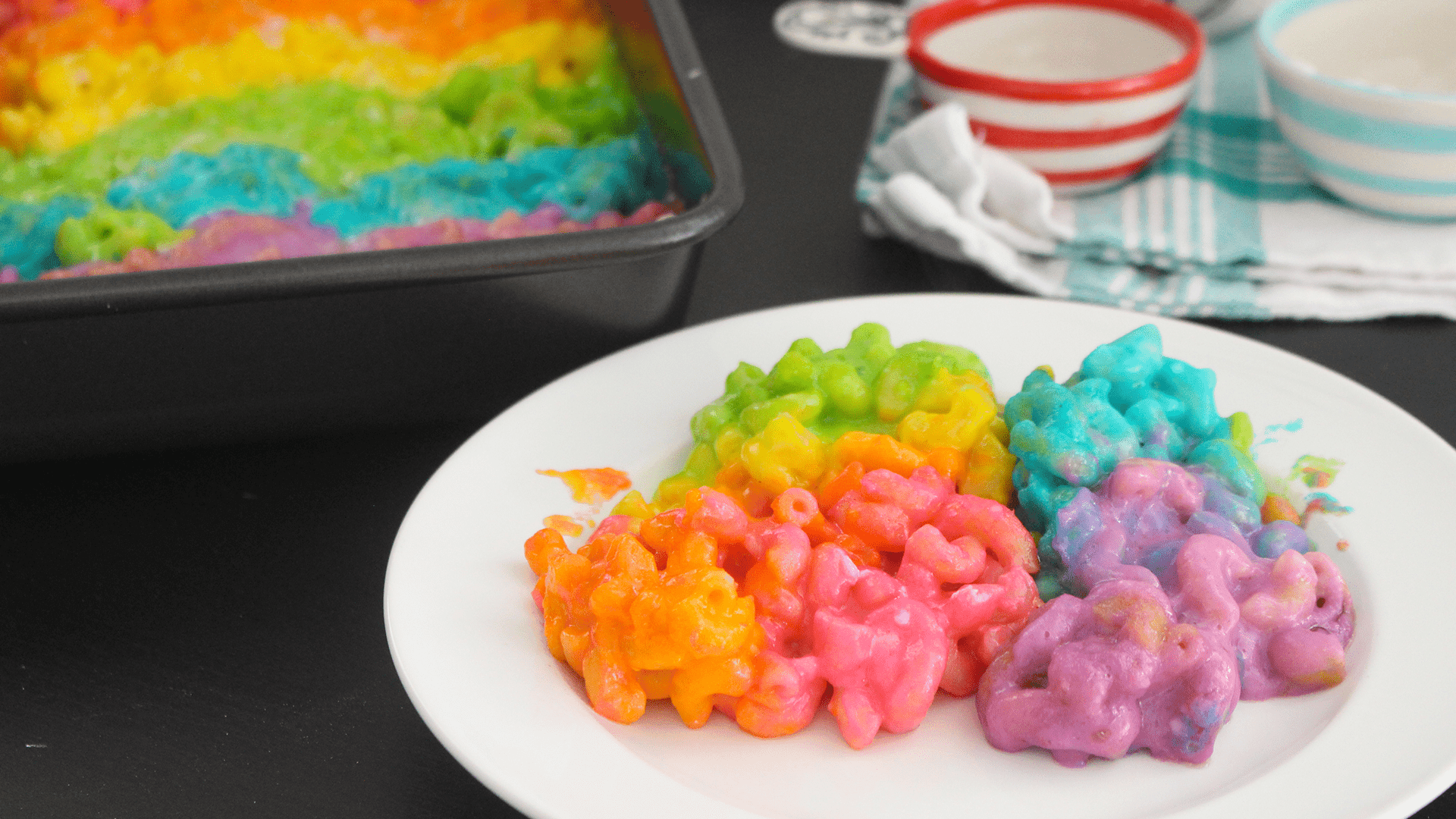 rainbow colored mac and cheese in a baking dish, colorful and vibrant
