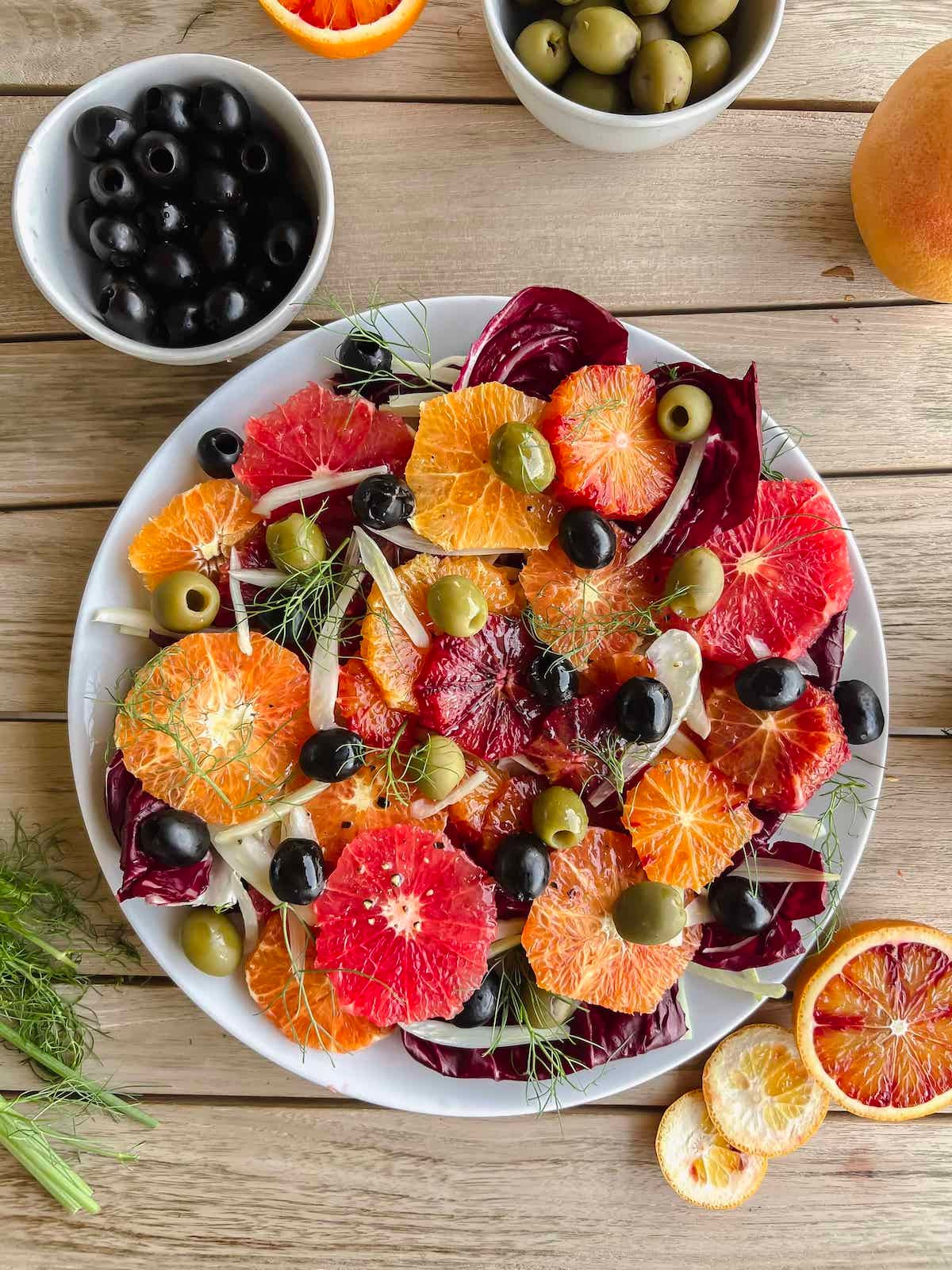 Fennel and Orange Fattoush with Olives on a rustic wooden table