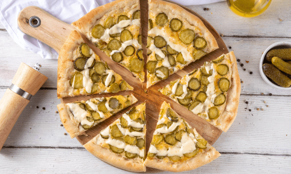 homemade pickle and pizza on wooden board