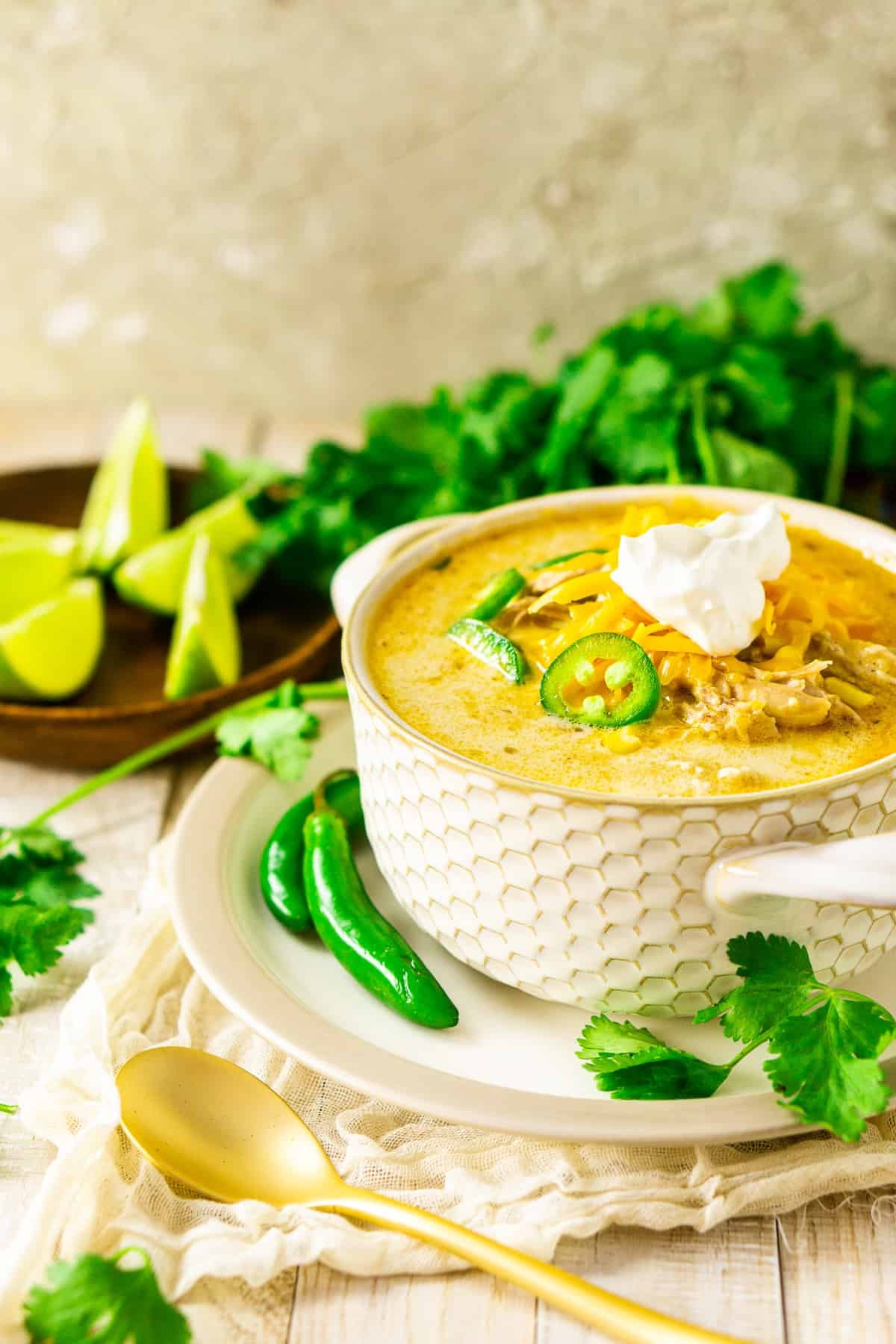 hearty bowl of creamy white chicken chili with fresh cilantro and lime