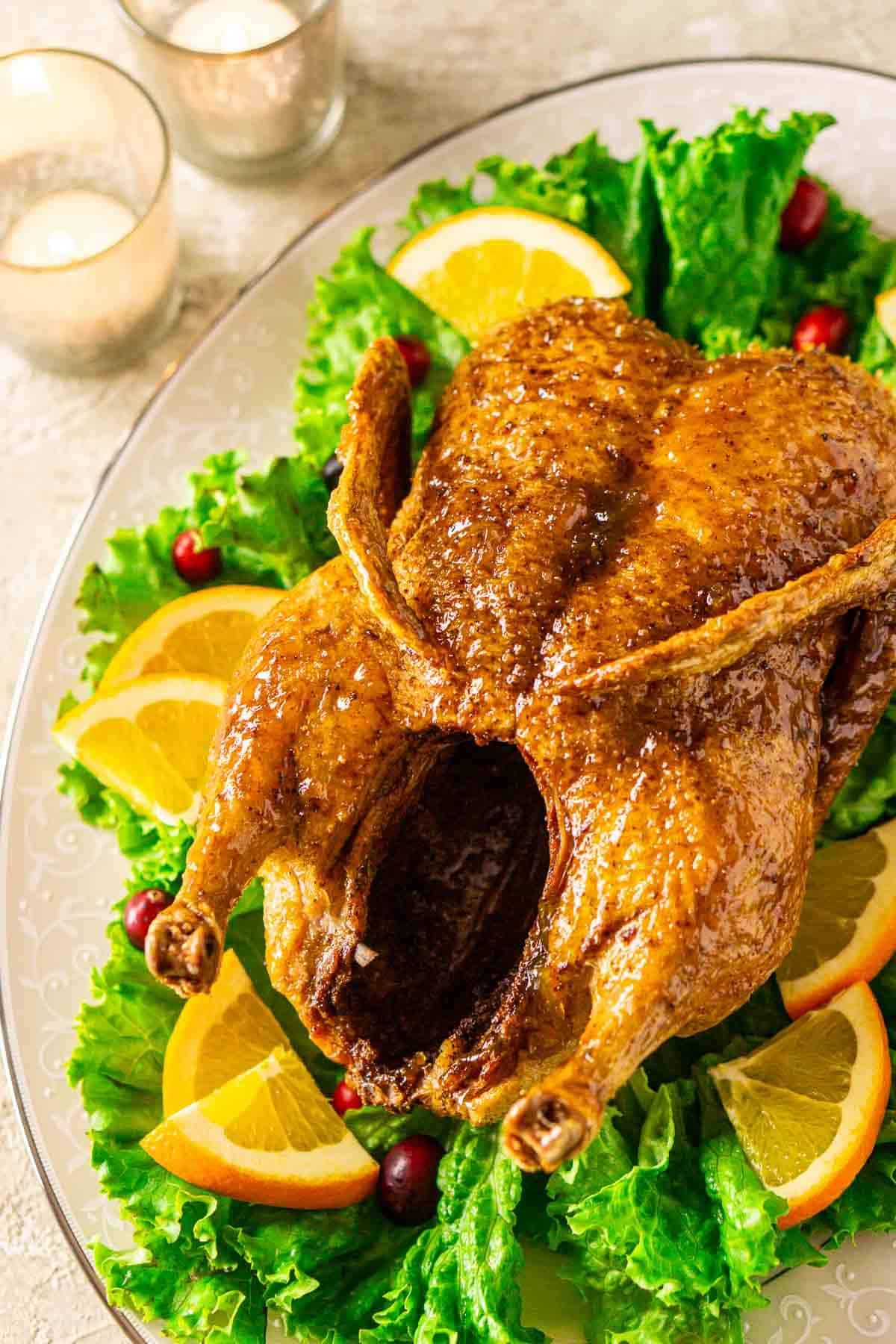 Citrus-glazed duck with fig jam, served on a rustic wooden board