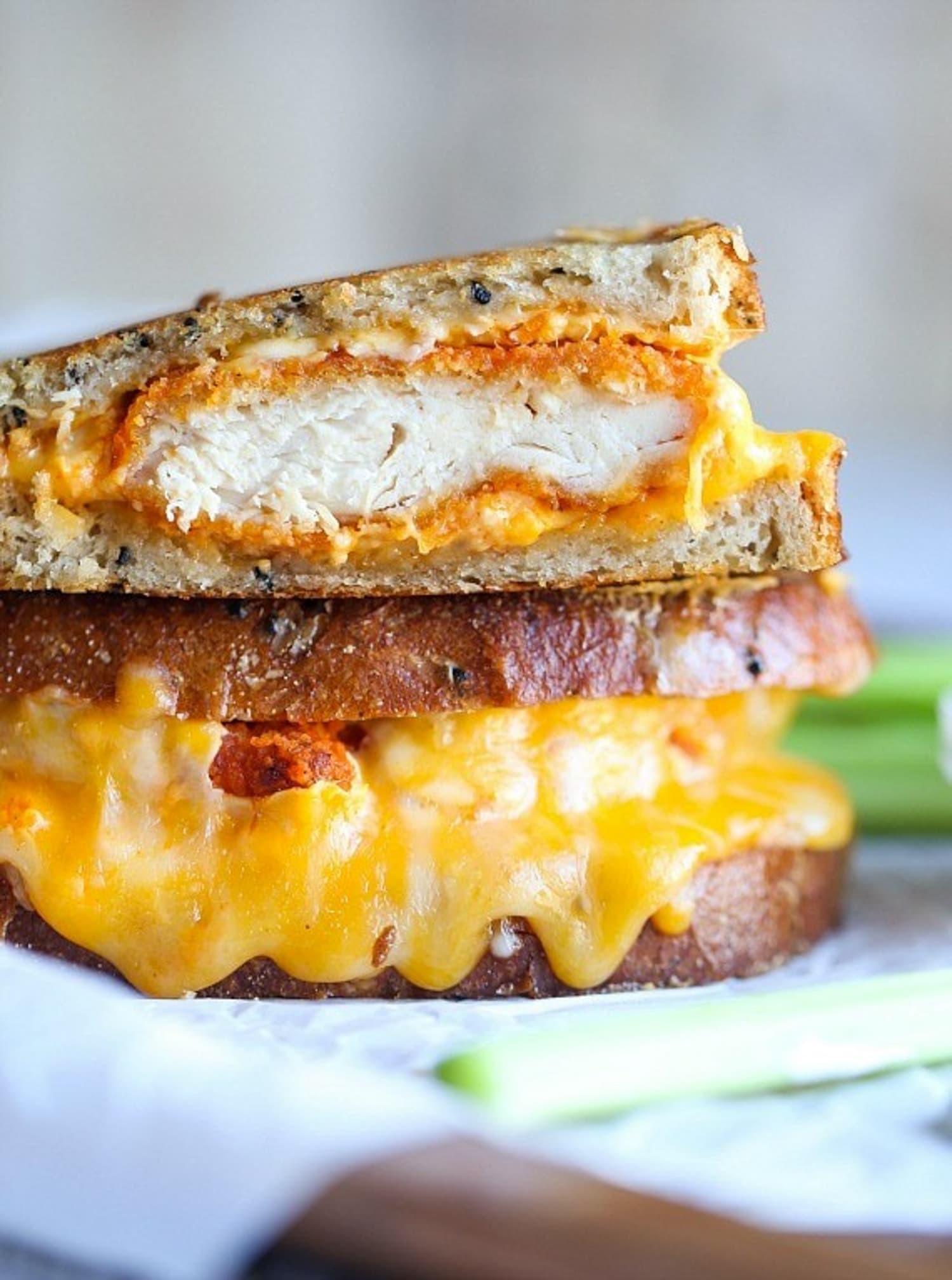 buffalo chicken grilled cheese sandwich cut in half showing melted cheese