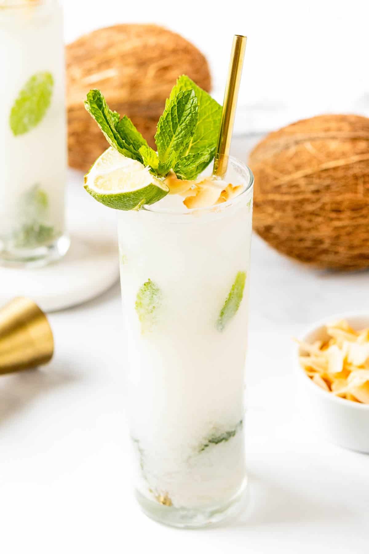 vibrant coconut mojito garnished with mint and lime on a festive, tropical-themed table