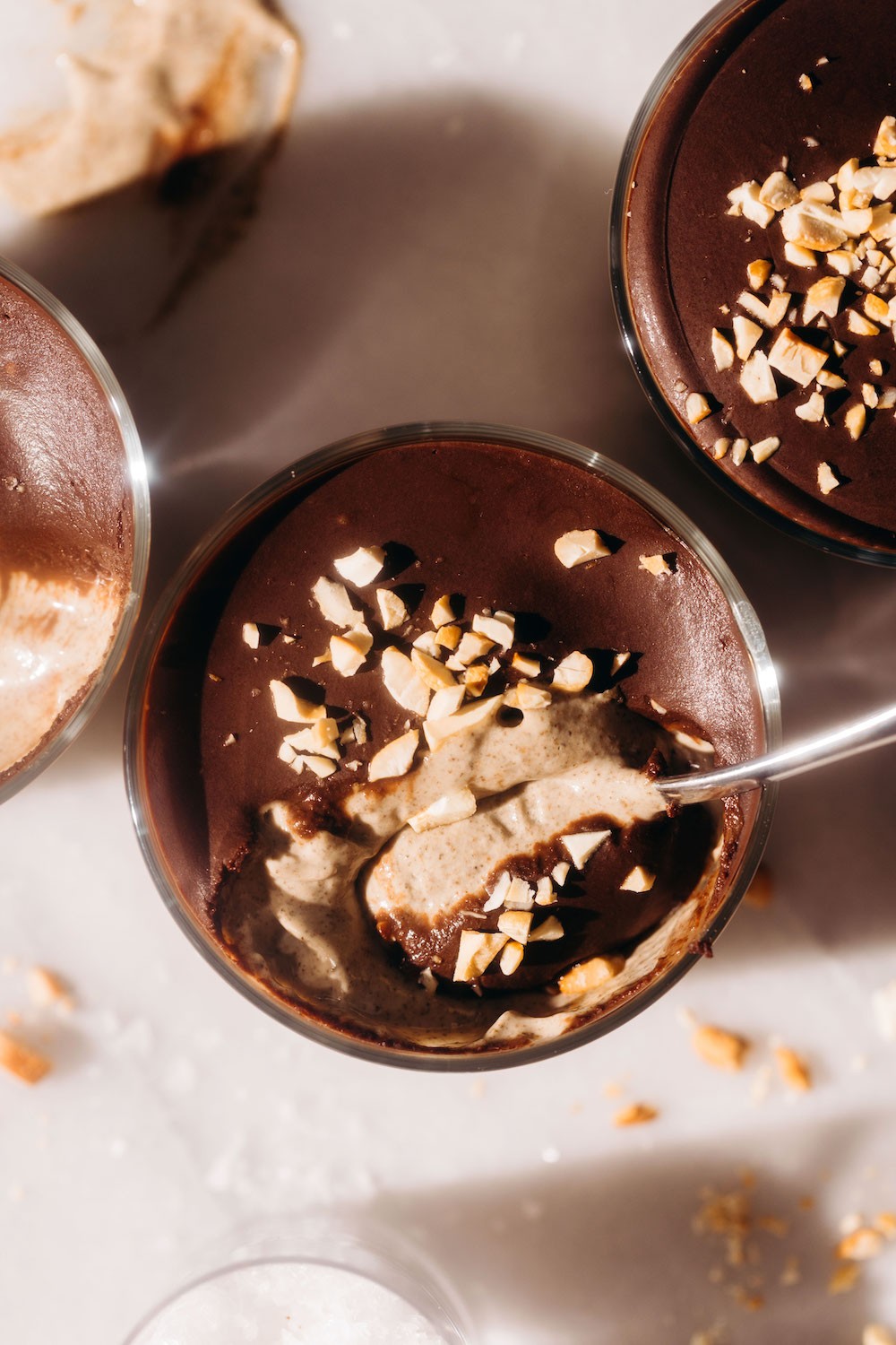 Close-up shot of a creamy peanut butter cup chia pudding in a glass jar, garnished with chocolate shavings and peanut butter swirls