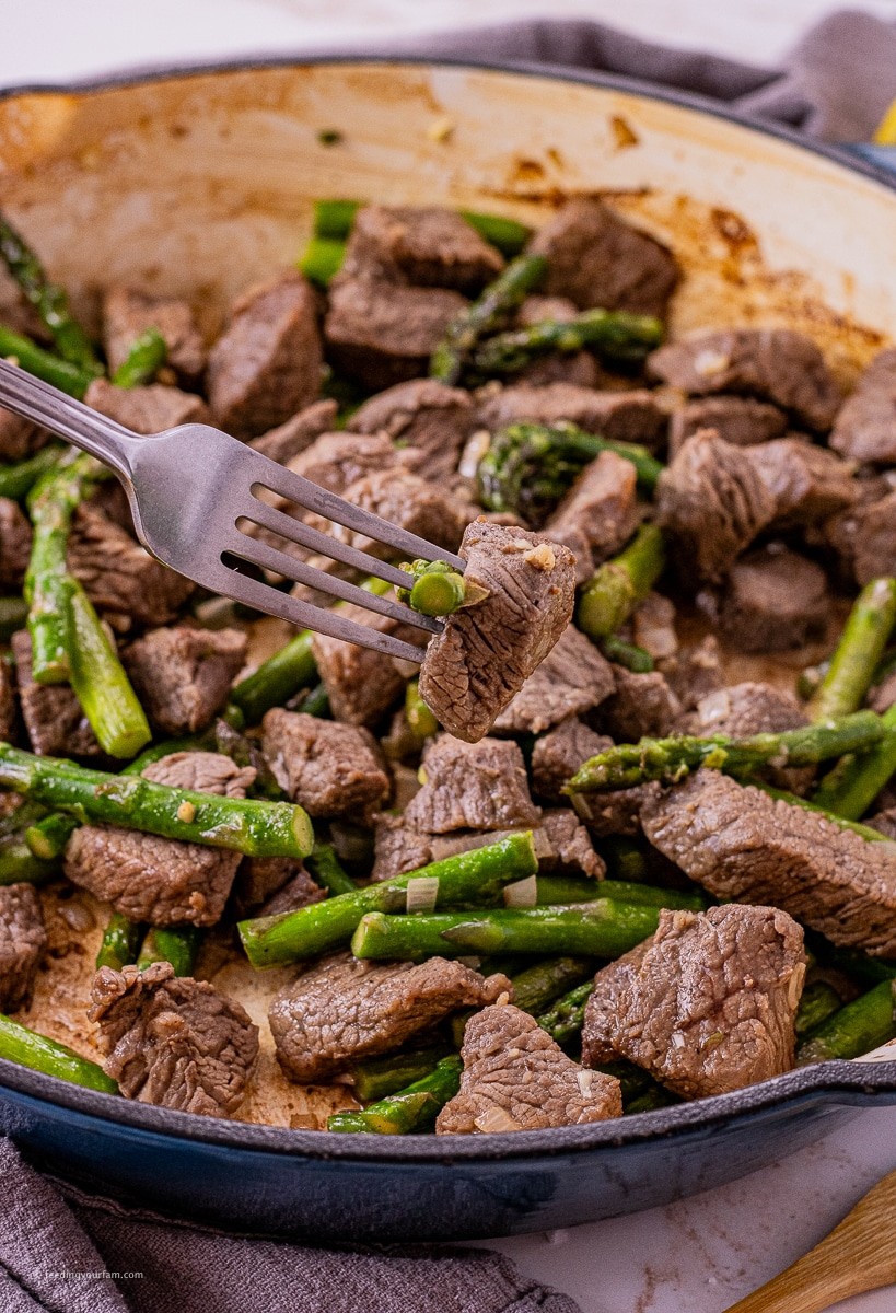 Garlic butter steak tips with asparagus in a bowl