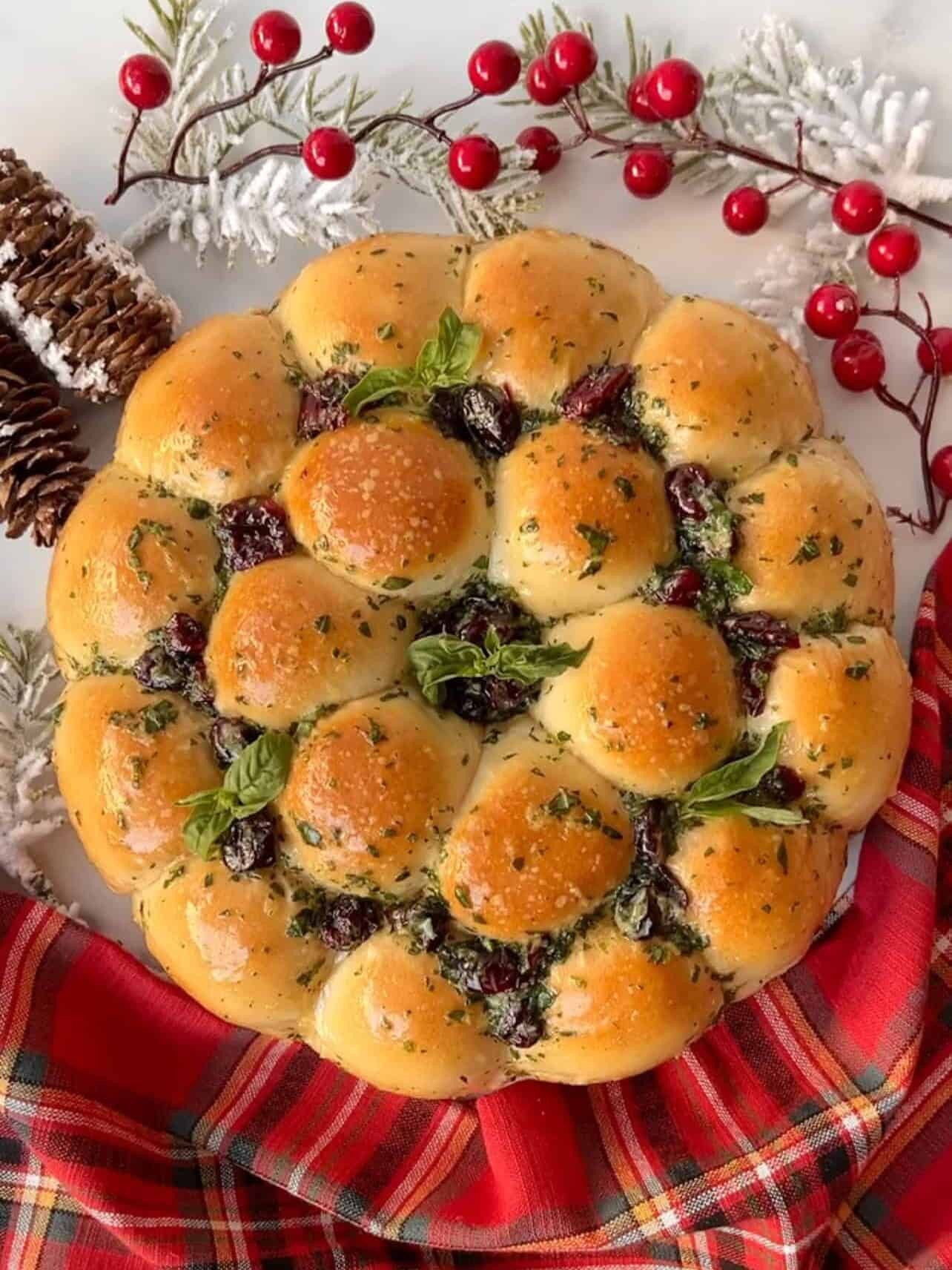 Platter of golden brown, cheese-stuffed garlic knots, garnished with fresh parsley, on a festive holiday table with bokeh lights.