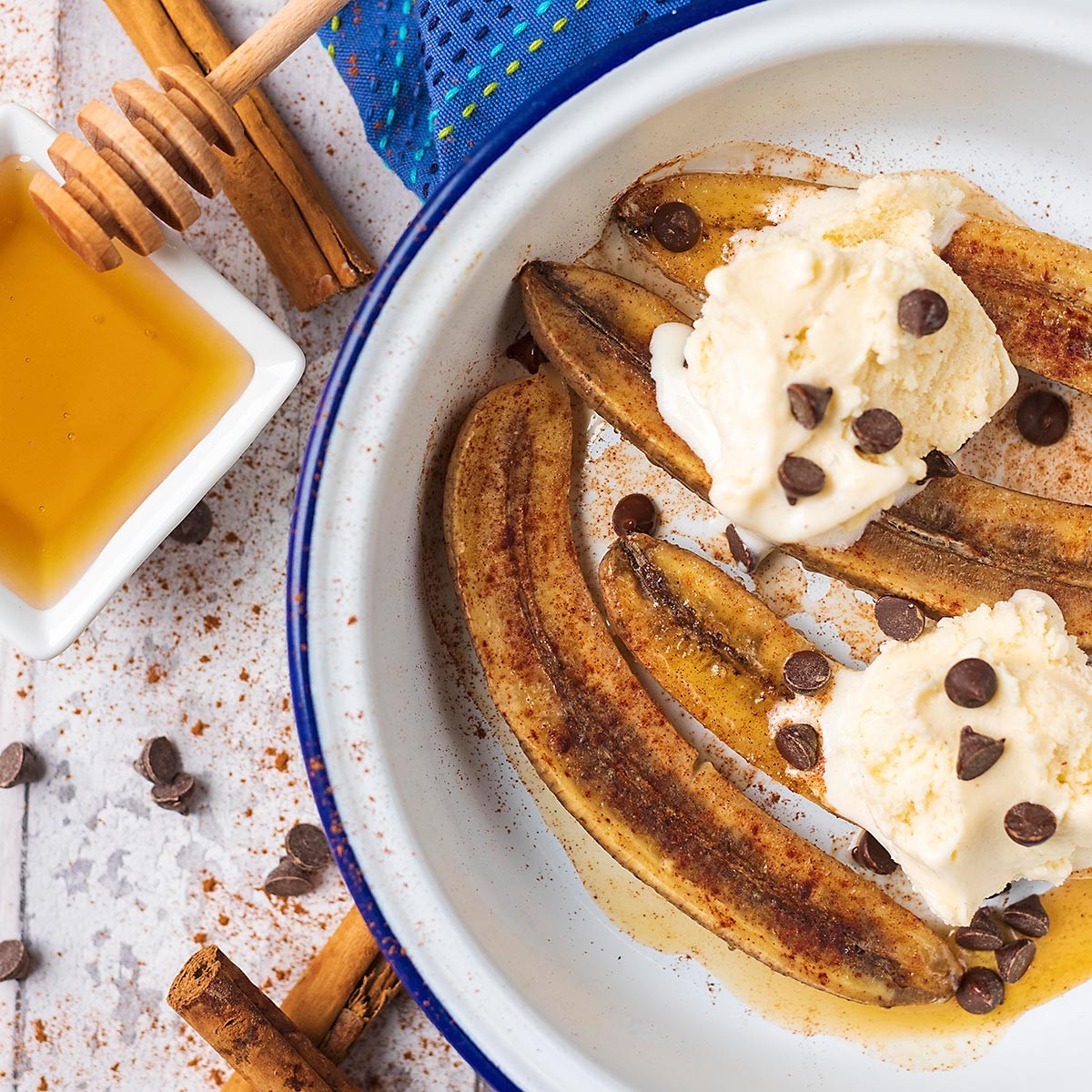 Close-up shot of baked bananas with honey drizzled on top