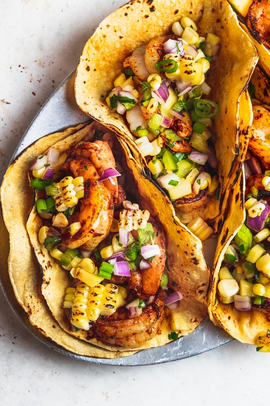 Spicy Shrimp Gyros with Mango Salsa on a wooden board