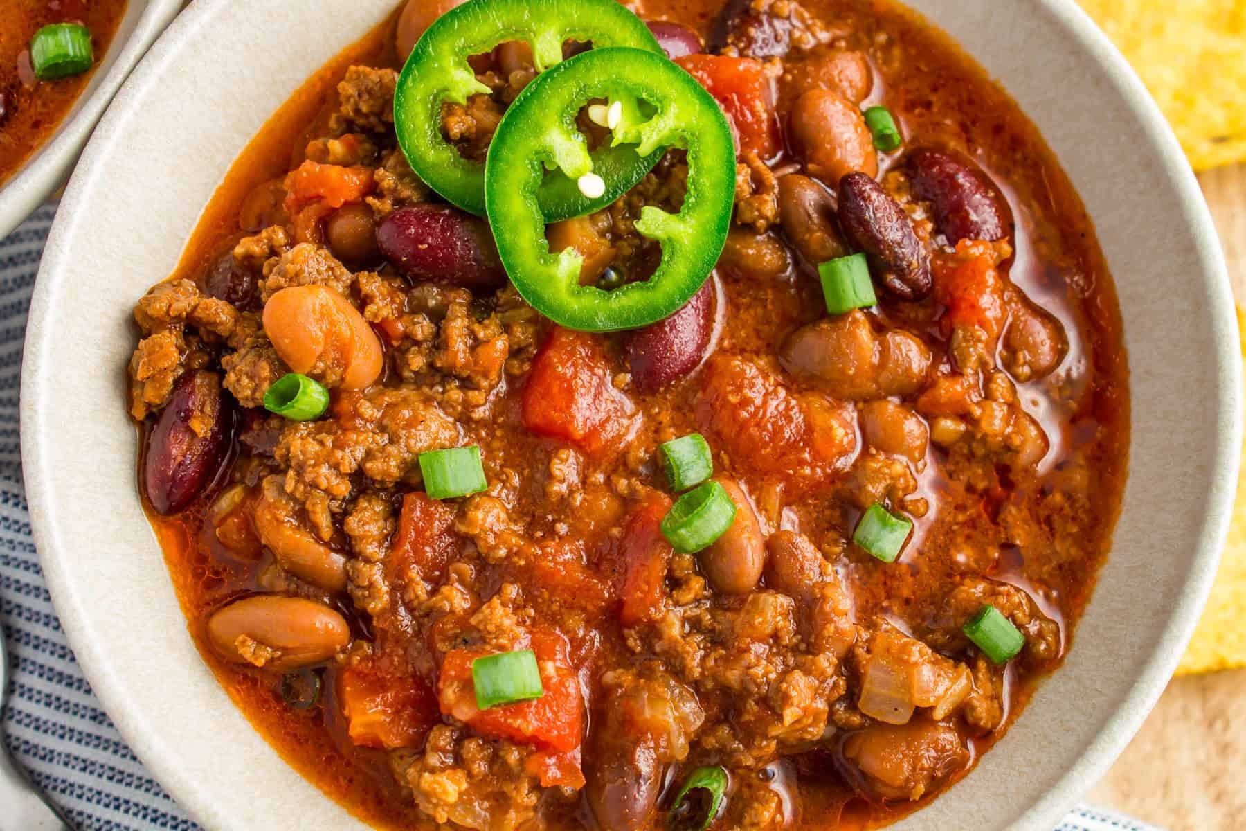 vibrant chili-fired skillet beef, close-up, steaming hot, garnished