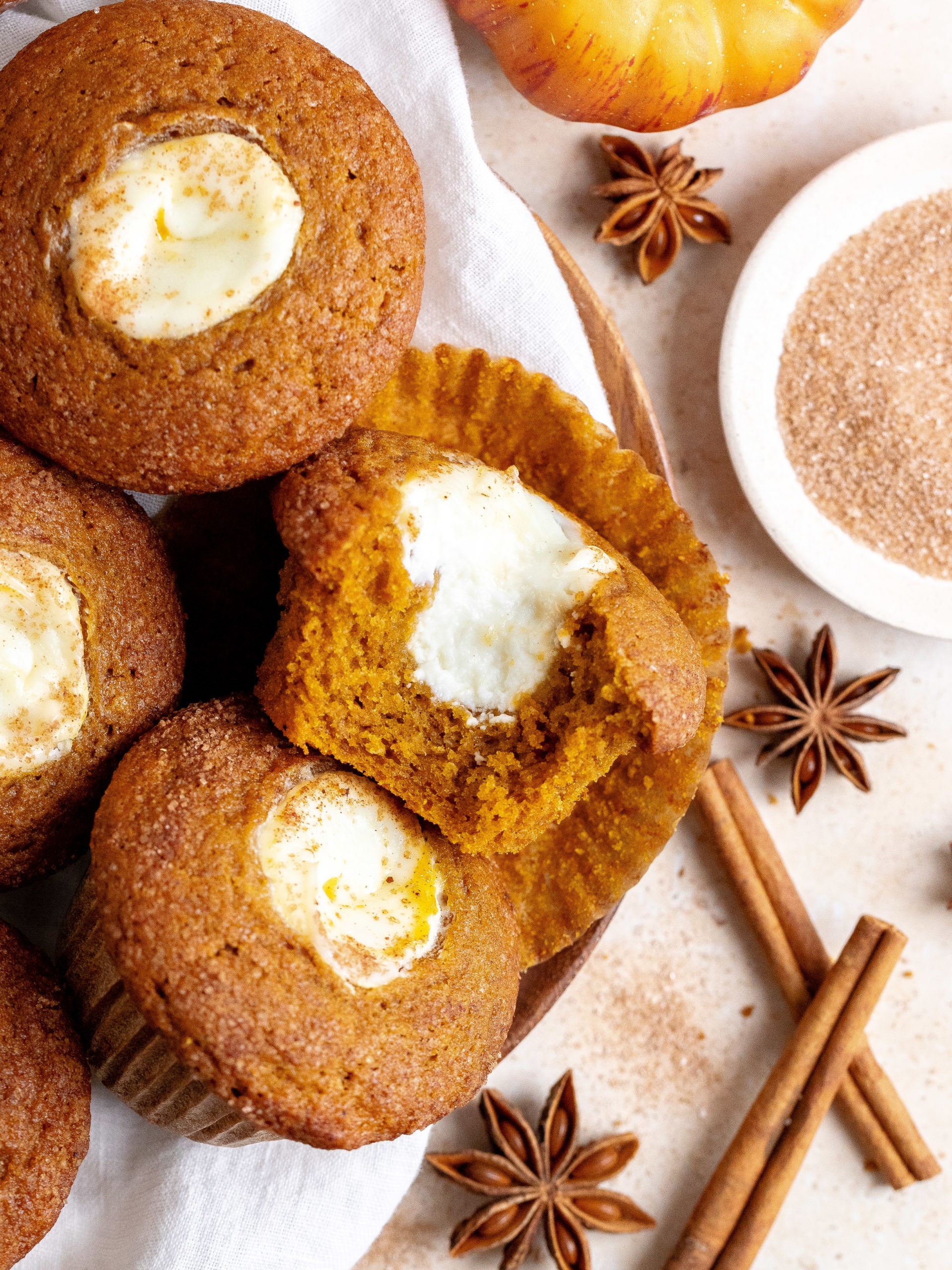 freshly baked pumpkin muffins with cream cheese frosting