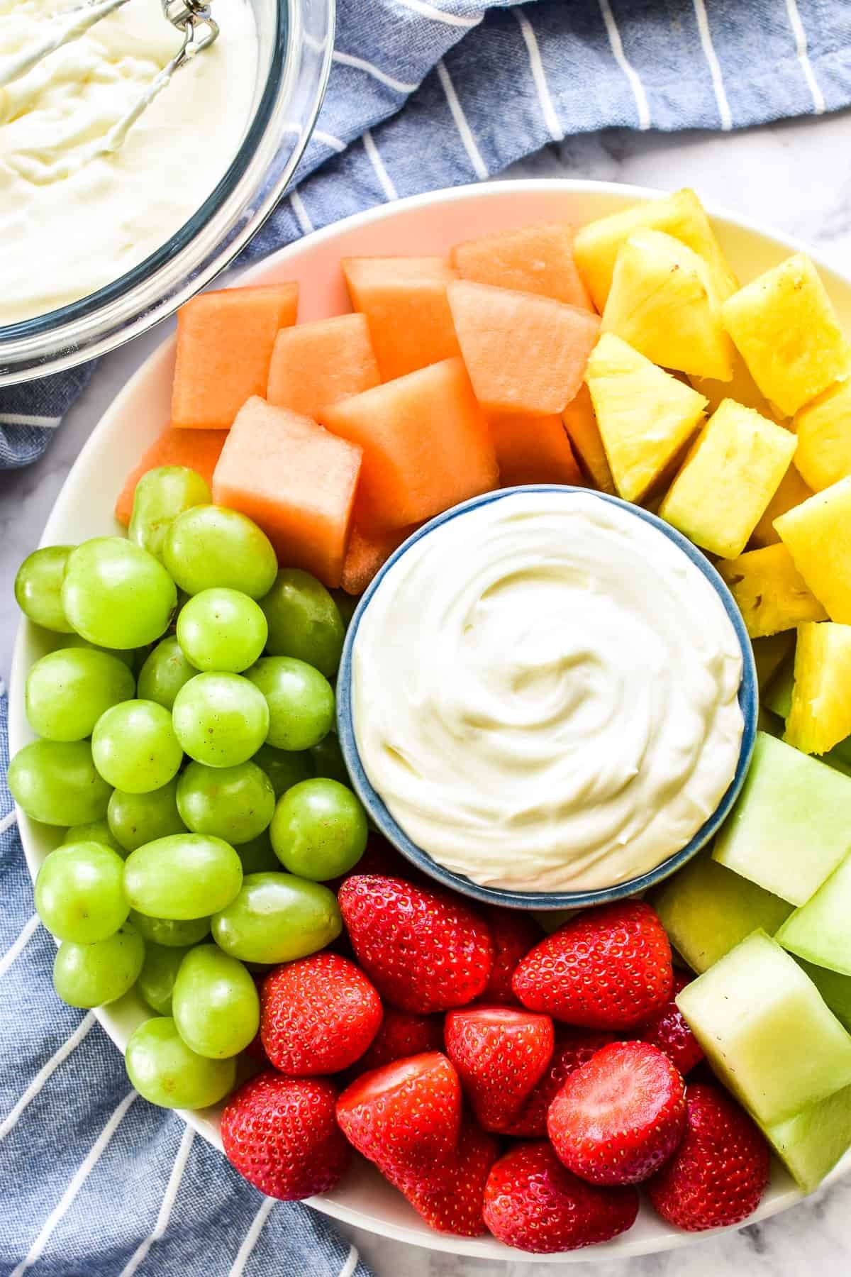 overhead shot of a vibrant berry platter with various fruits and dips