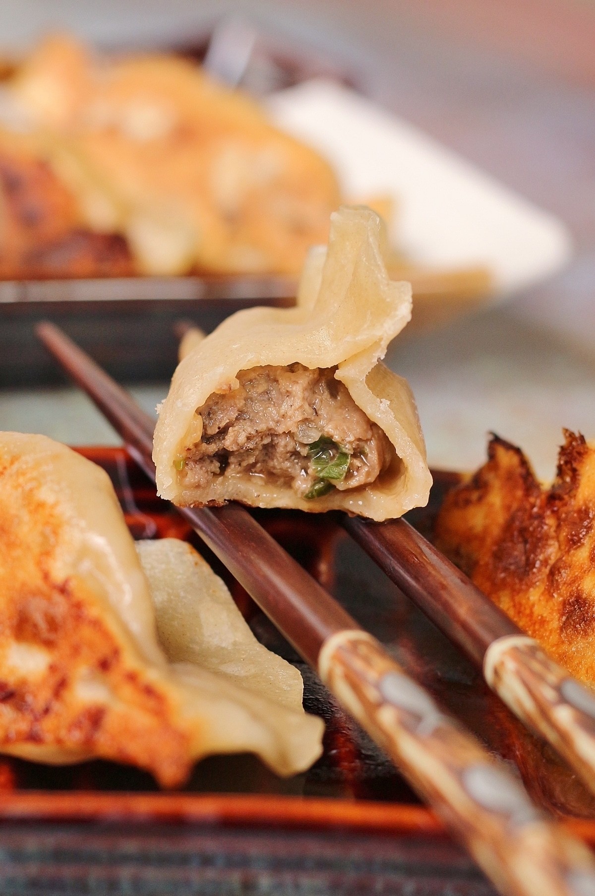 Spicy beef and cabbage dumplings served on a rustic wooden plate