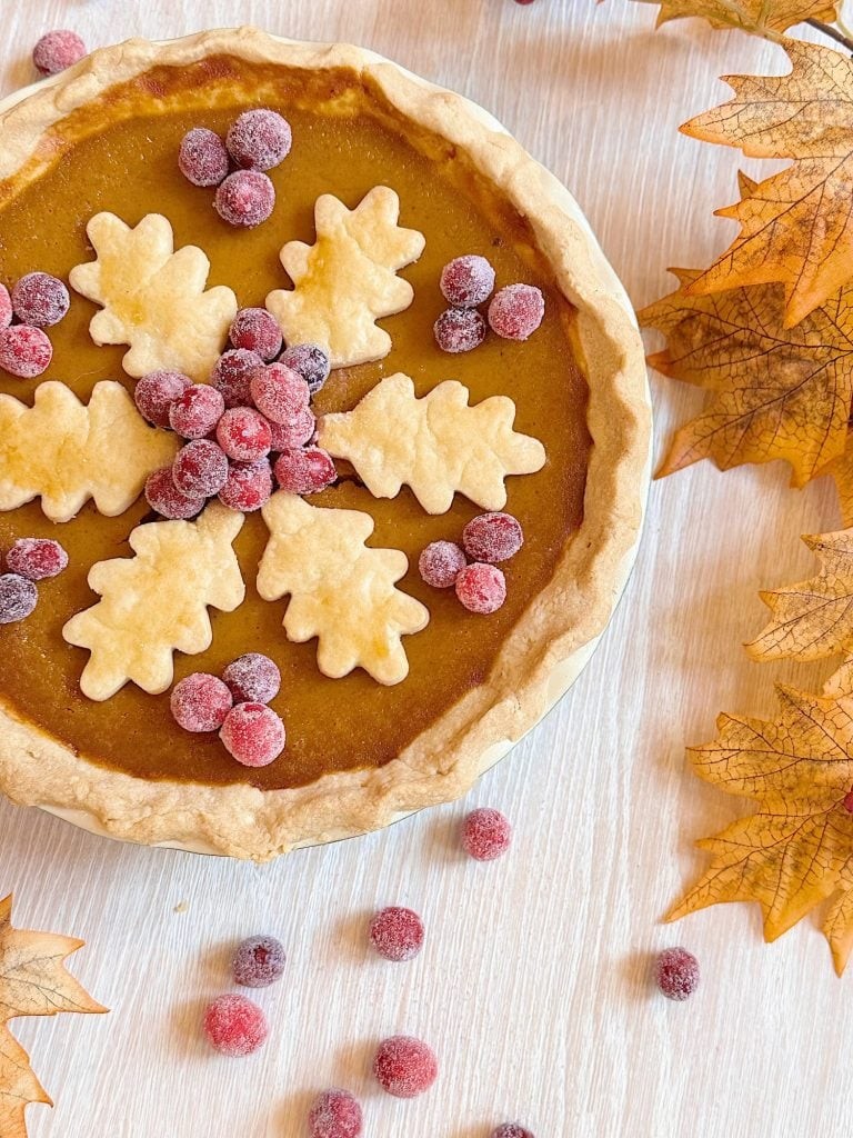 vintage pumpkin pie with a golden crust and creamy custard filling, autumnal decorations