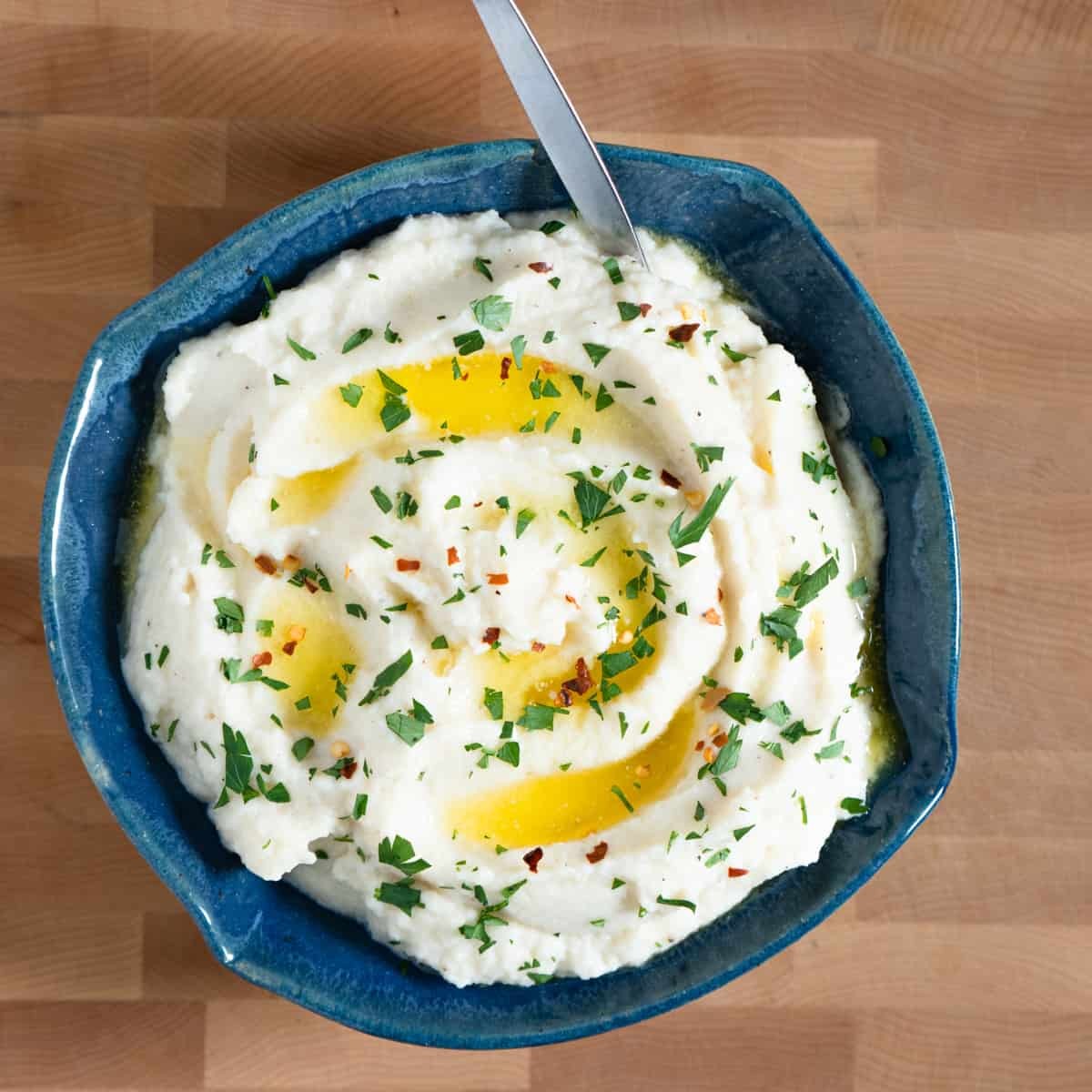 bowl of callaloo and celery root puree garnished with herbs