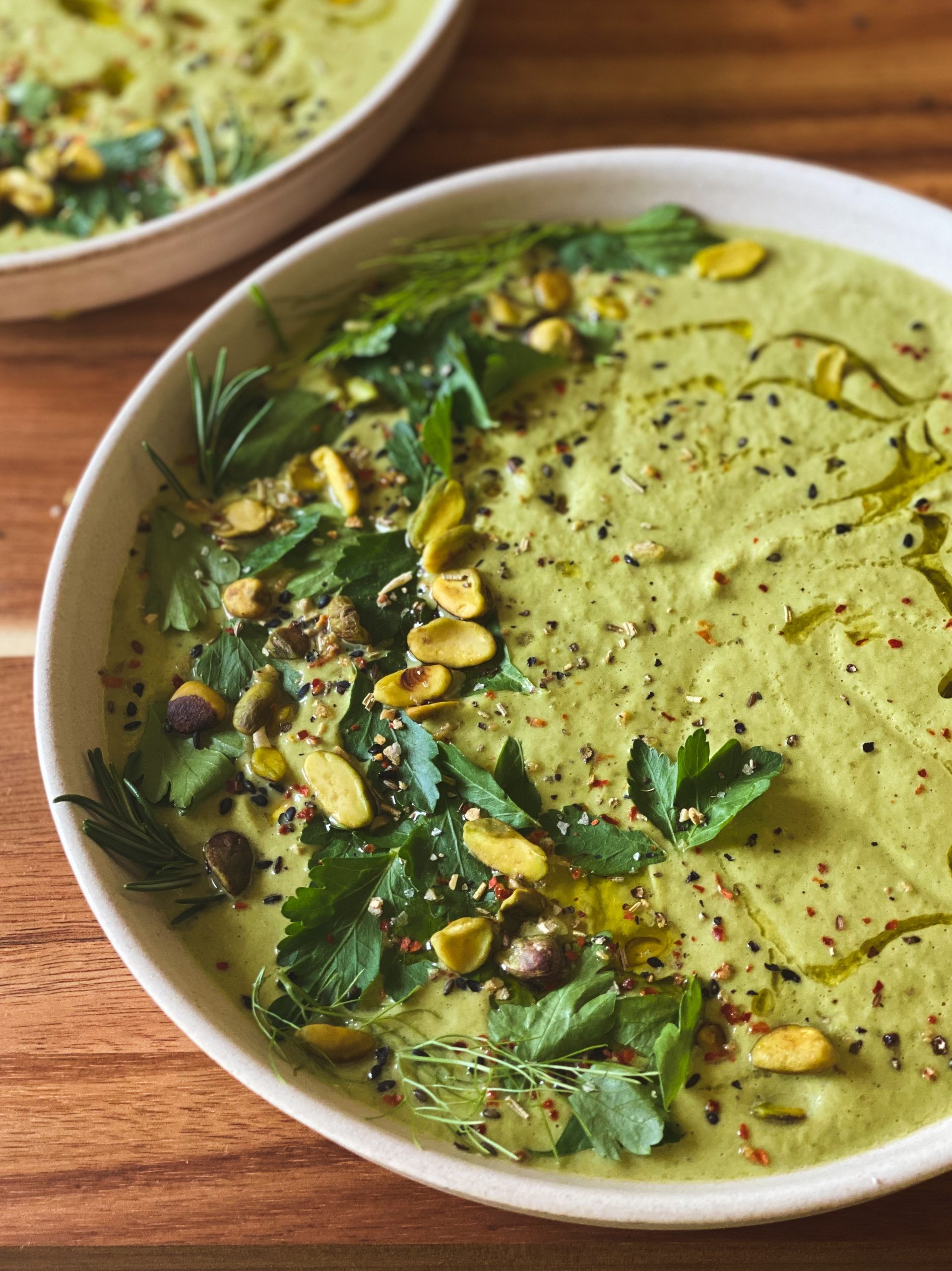 creamy keto pistachio soup in a bowl with pistachios sprinkled on top