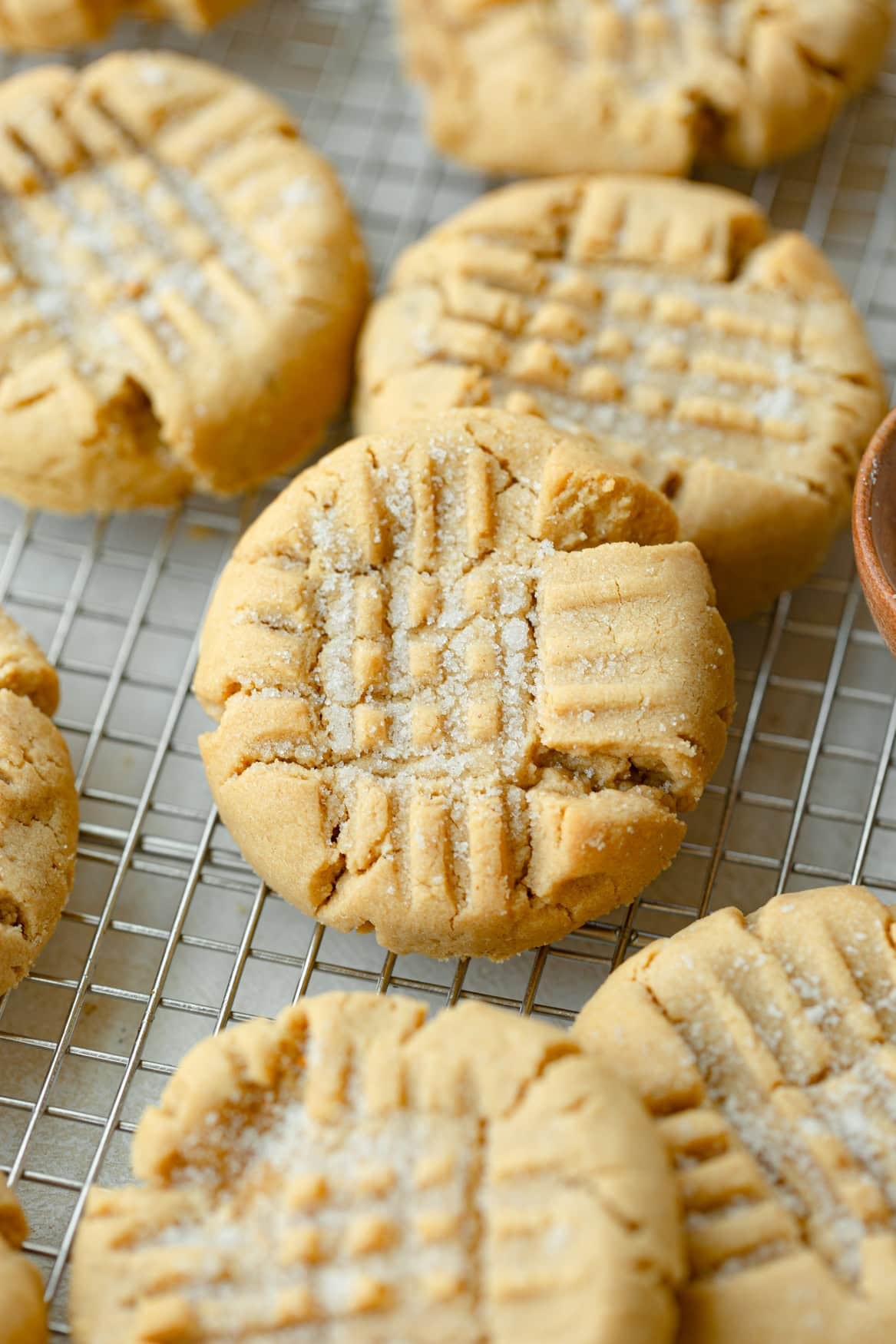 freshly baked peanut butter cookies with perfect crisscross pattern on a cooling rack