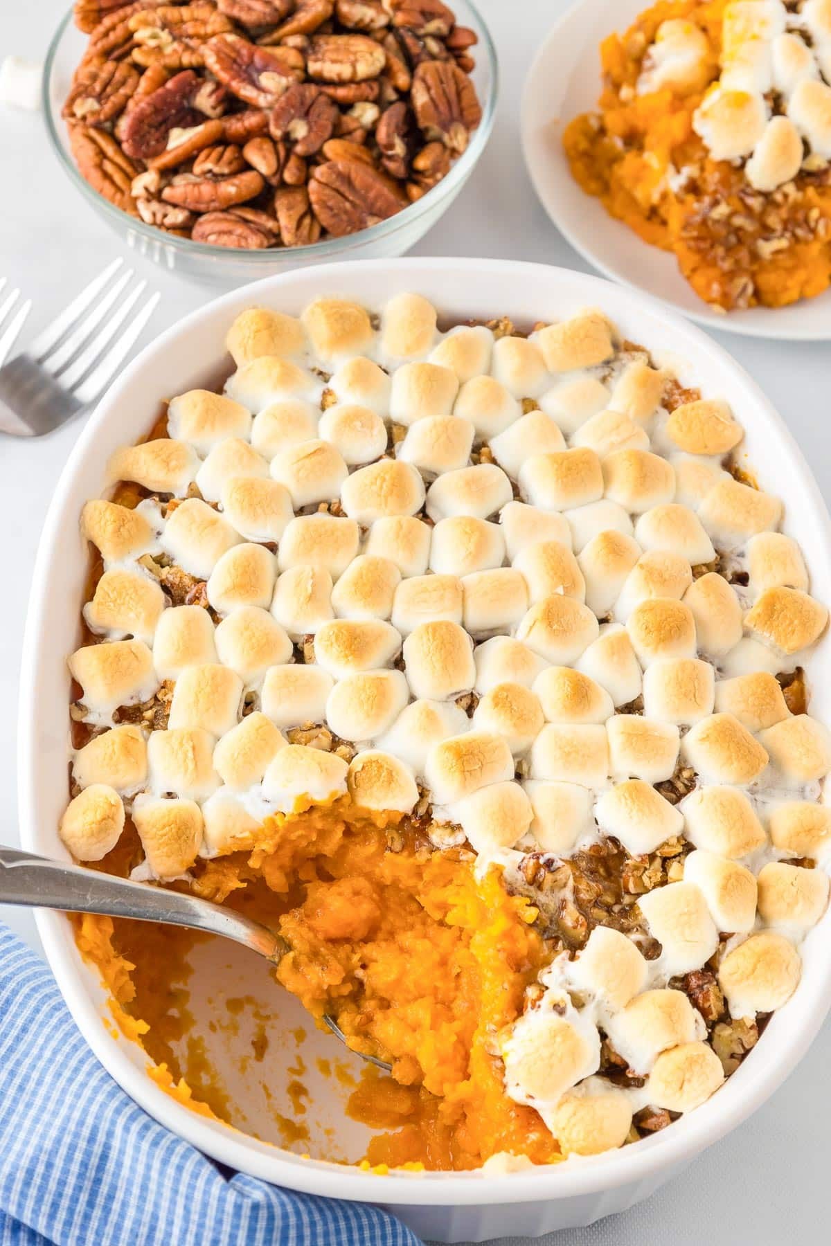 vibrant sweet potato casserole with maple butter drizzle and toasted pecans, holiday table setting