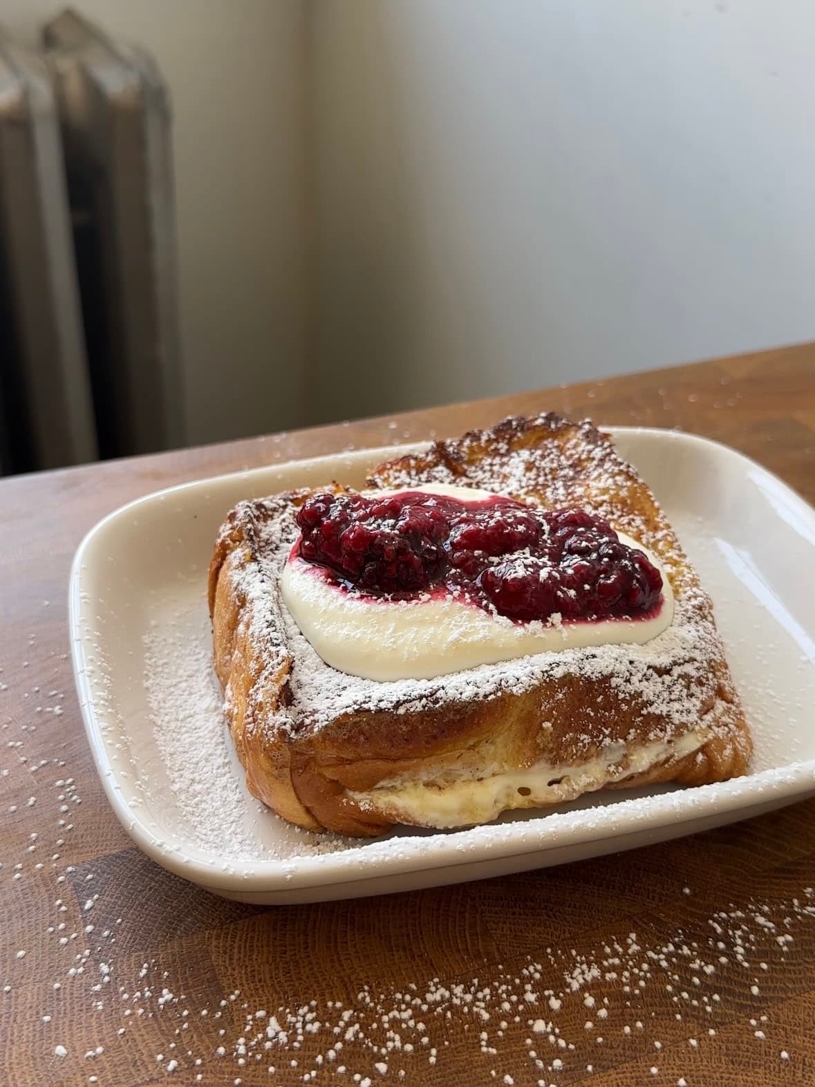 lemon ricotta french toast with poppy seeds on a plate