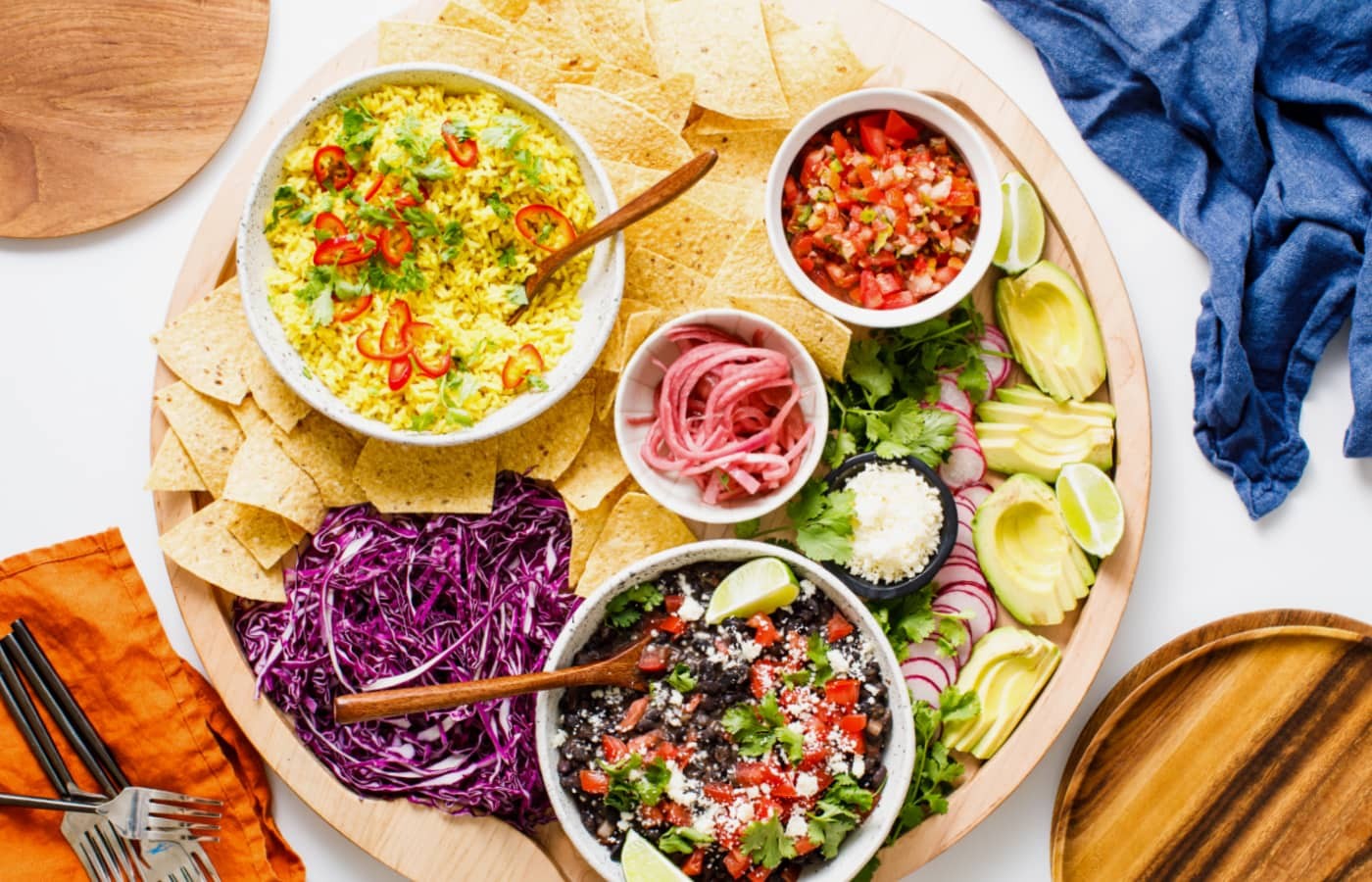 overhead shot of colorful, homemade weekend lunch burritos on a wooden board with fresh ingredients