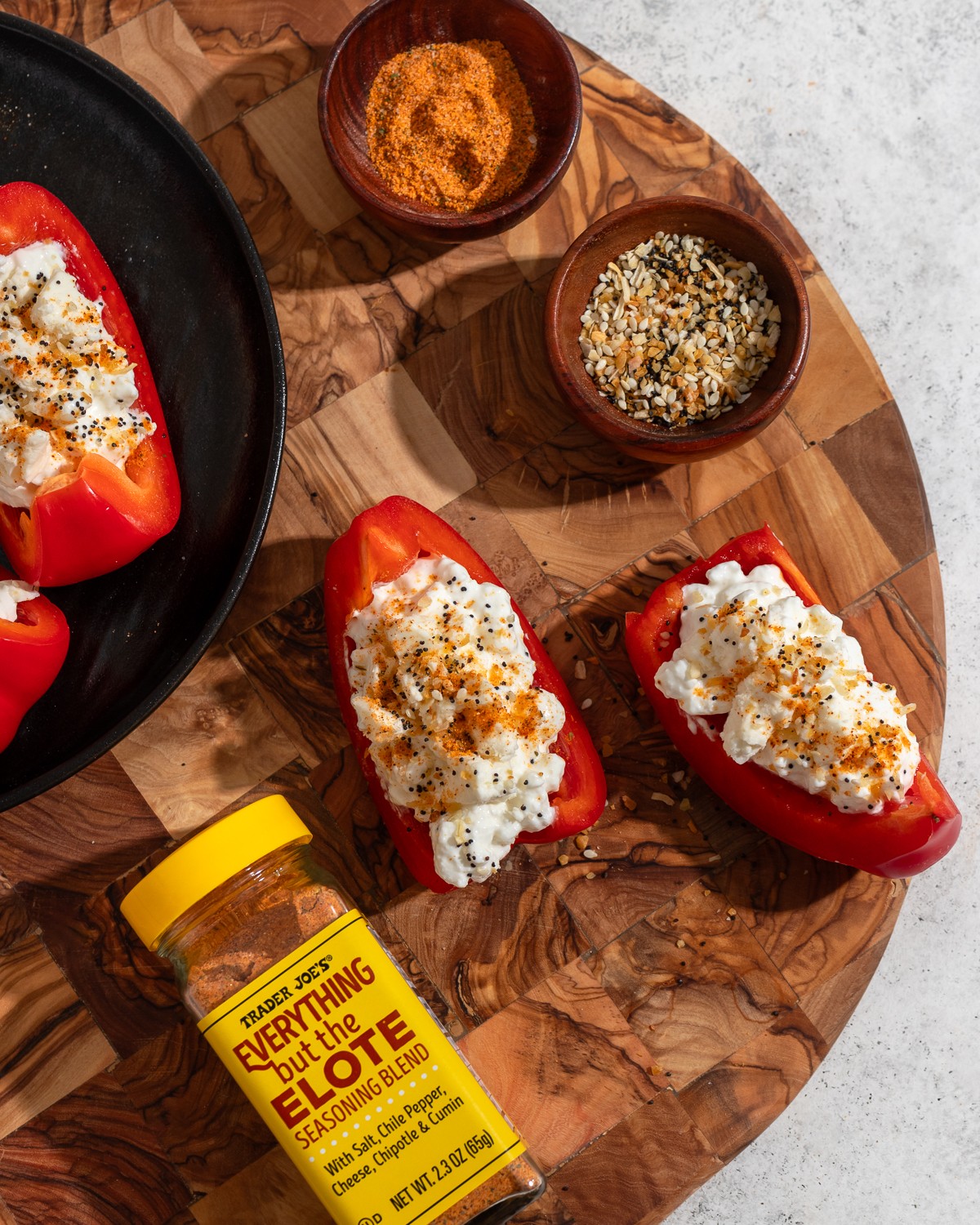 paprika feta stuffed bell peppers on a wooden cutting board