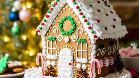 Cozy, warm gingerbread house, decorated with icing and candies, festive lighting