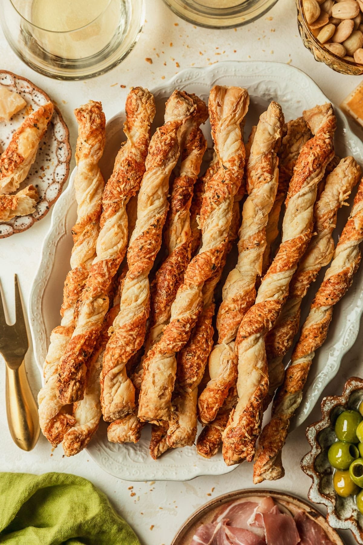 golden brown savory parmesan puff pastry twists on a baking sheet, close-up, natural light
