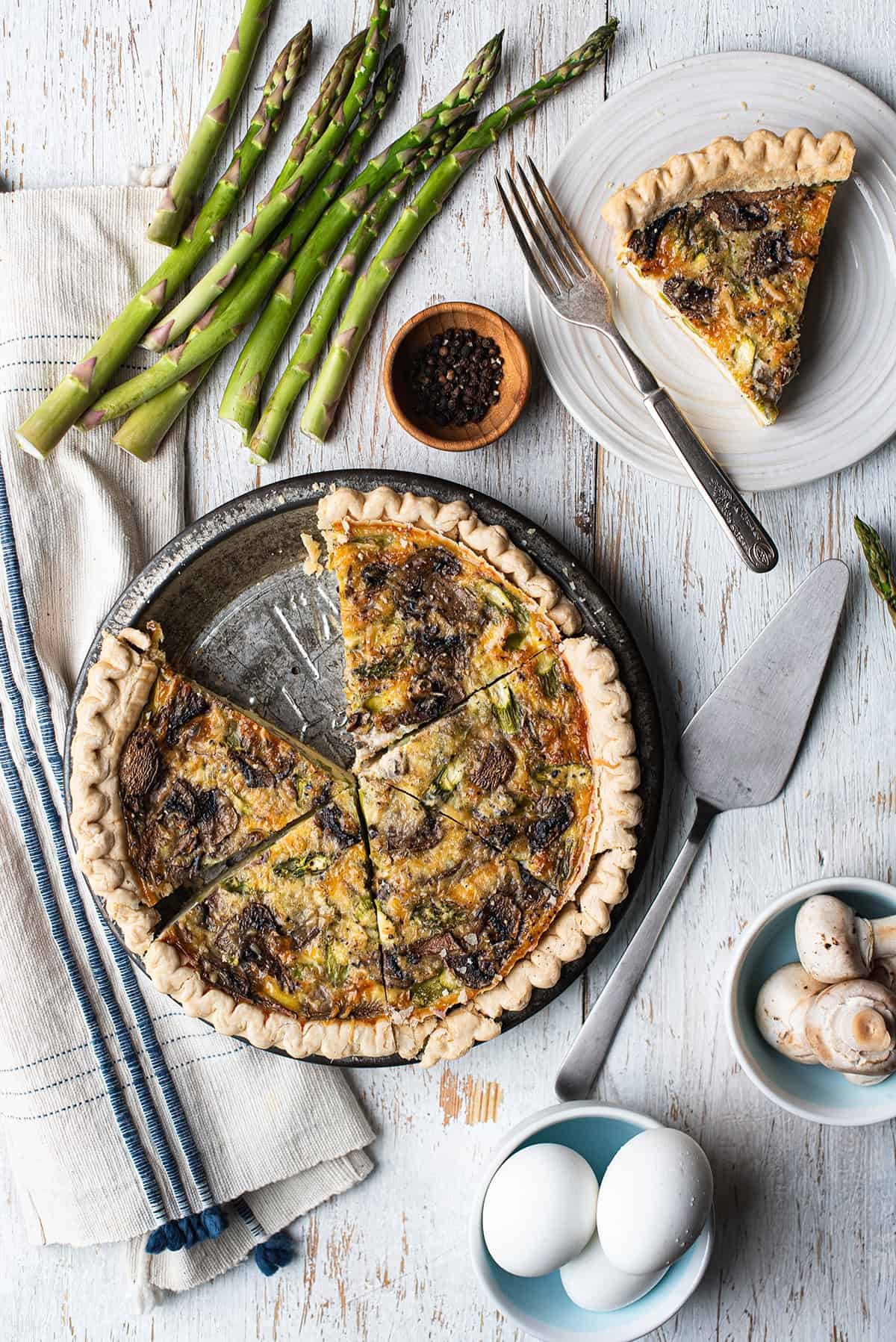 Asparagus and Smoked Gouda Quiche on a rustic wooden table