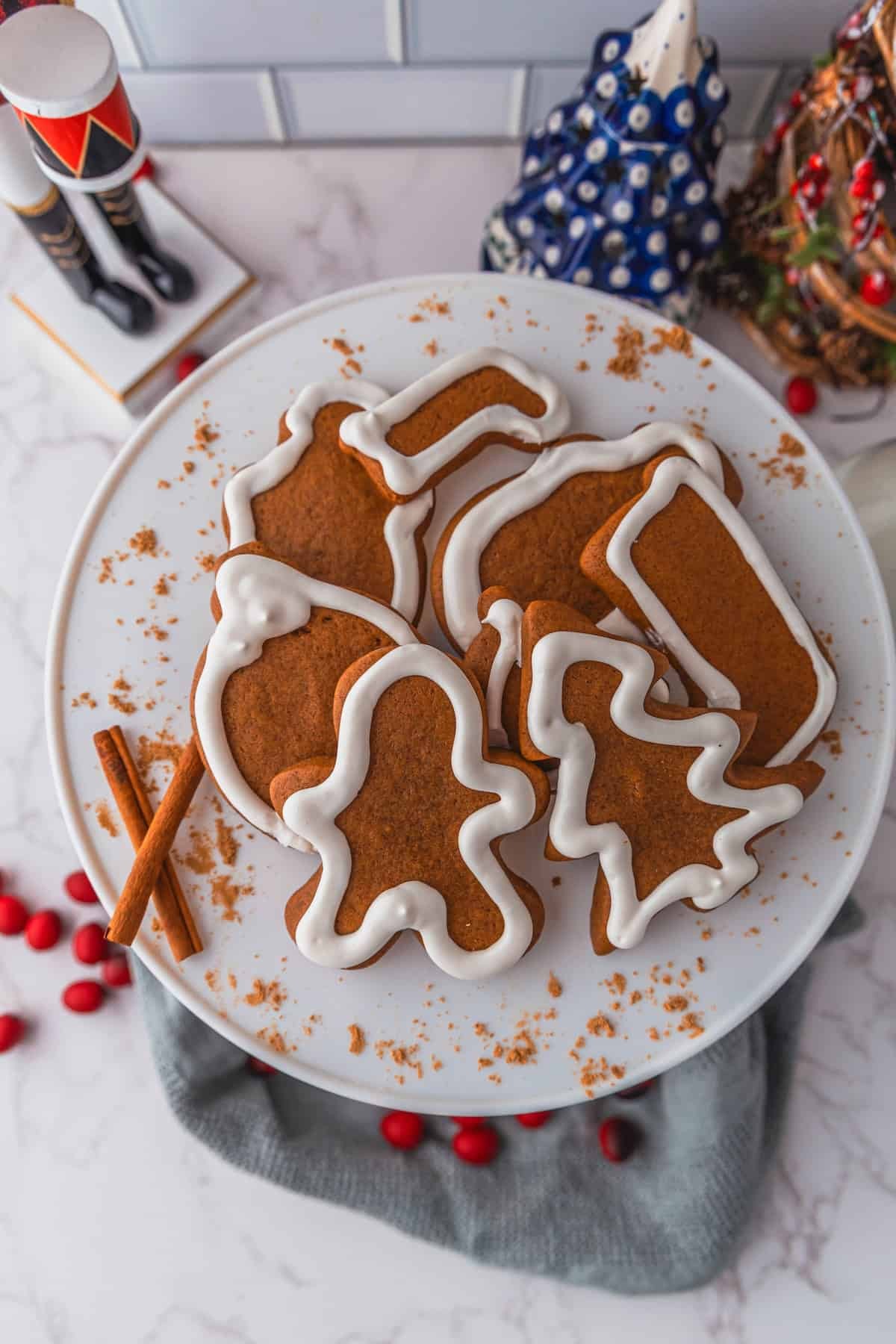 Beautifully decorated gingerbread cookies with white icing on a festive plate, warm lighting