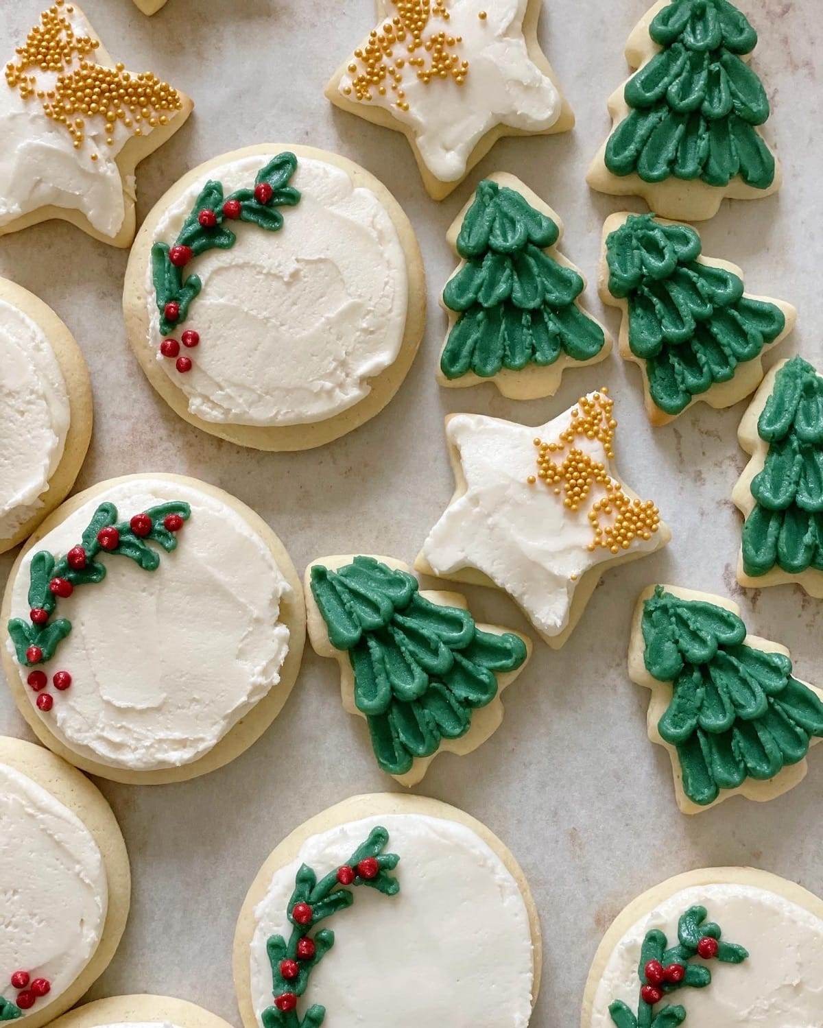 beautifully decorated Christmas french tip sugar cookies on a festive plate
