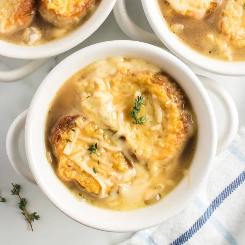 A rustic bowl of keto french onion soup with bubbling cheese