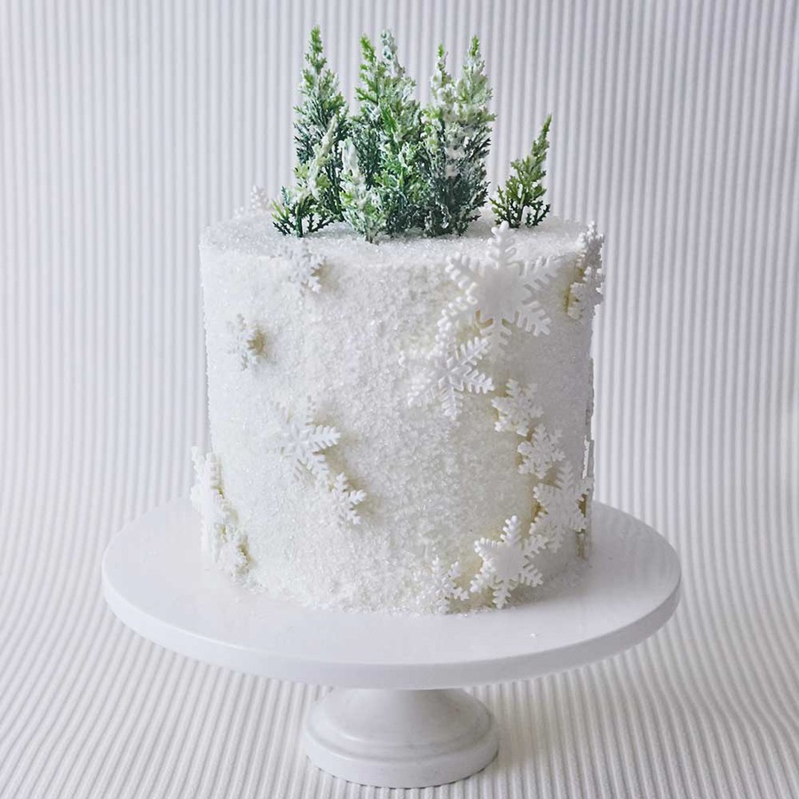 Winter themed birthday cake with snowflakes and edible glitter