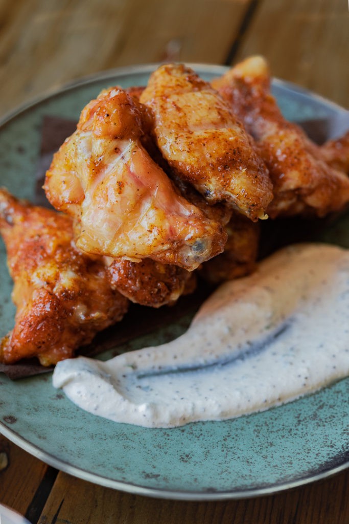 close up of peach habanero wings on a platter