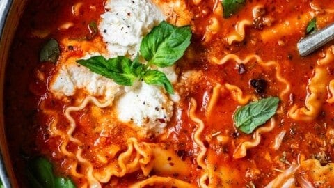 bowl of steaming lasagna soup with fall leaves in the background