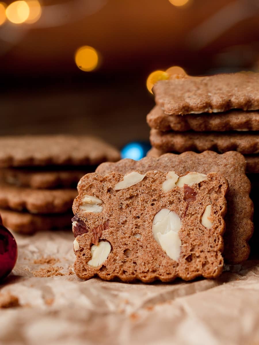 golden brown almond cookies with crisp edges on a cooling rack, sunlight, rustic kitchen