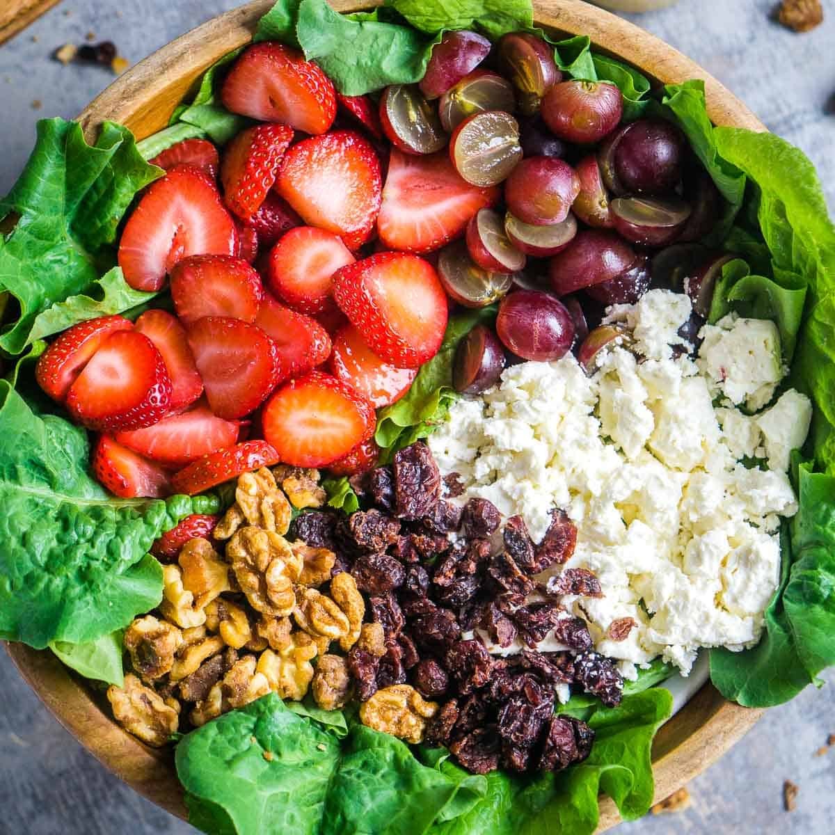 fresh spring chervil strawberry salad on a rustic wooden table