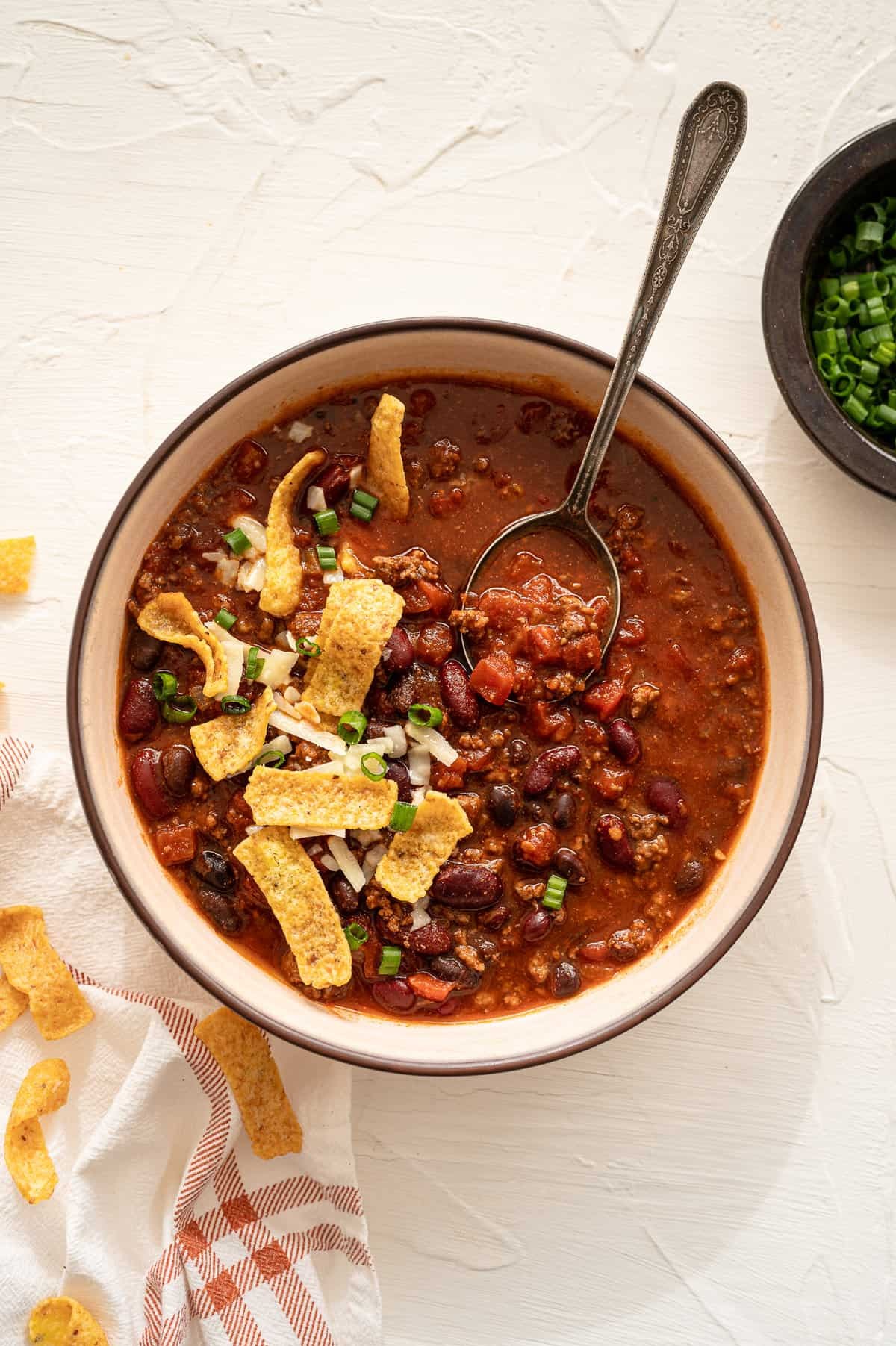 a pot of homemade chili simmering on a stove